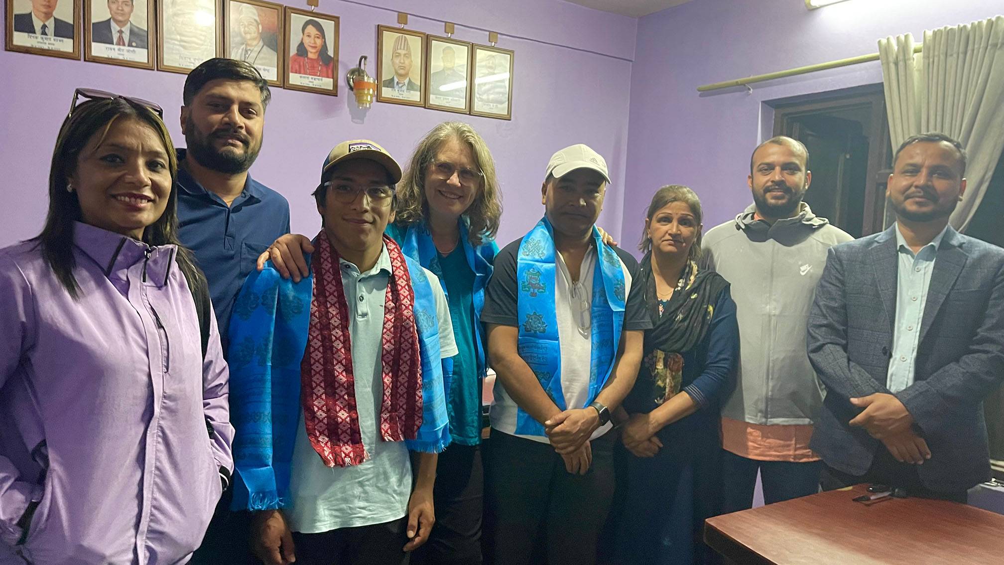 Wissler and her son Dante pose for a photo with National Deaf Federation Nepal staff.