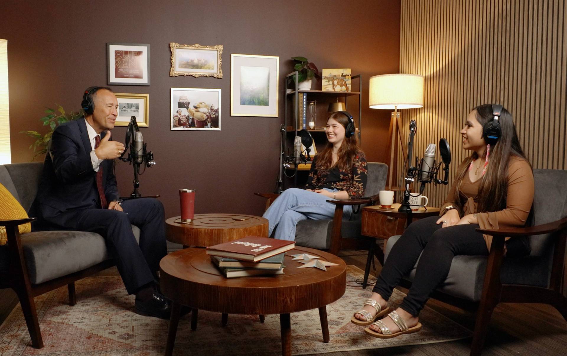 President damphousse speaks with two women in a podcast studio