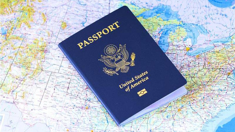 A passport book on top of a map.