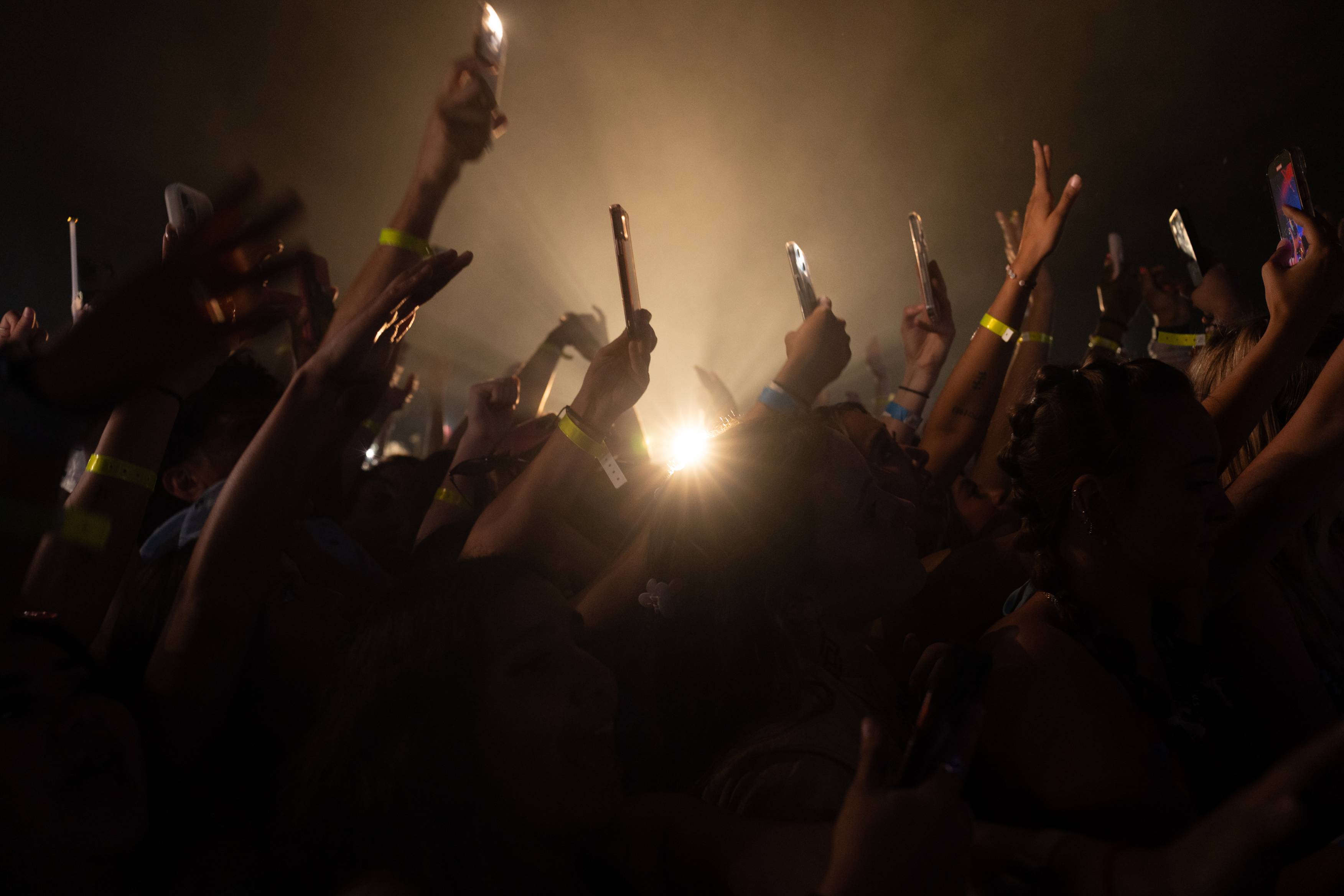 Photo of Students attending River Fest - a group of students holding up cameras to take a picture of music artist