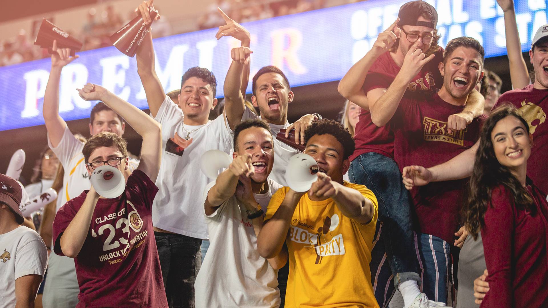 students cheering in an football football game