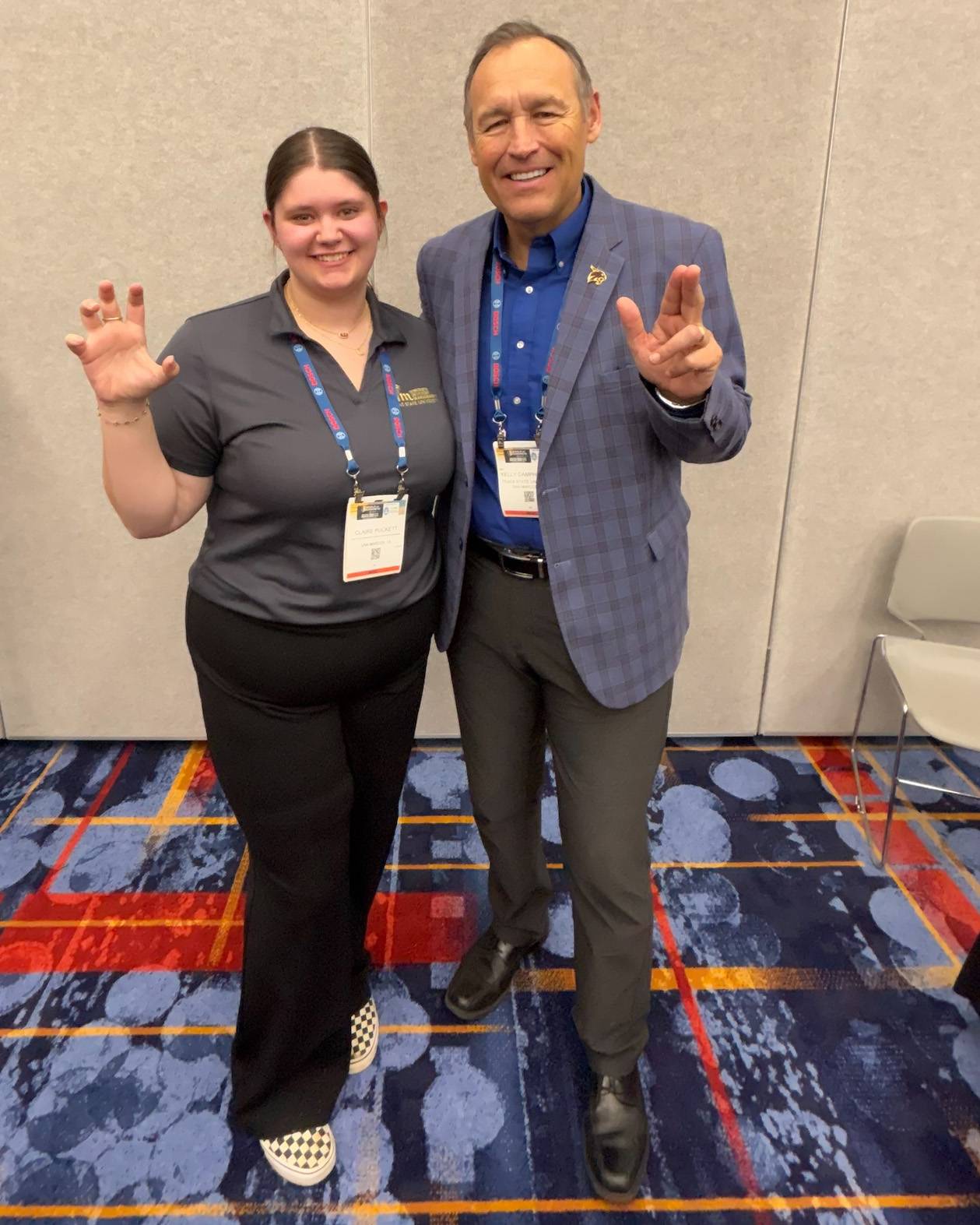 Claire Puckett (left) poses for a photo with President Kelly Damphousse at the World of Concrete trade show.