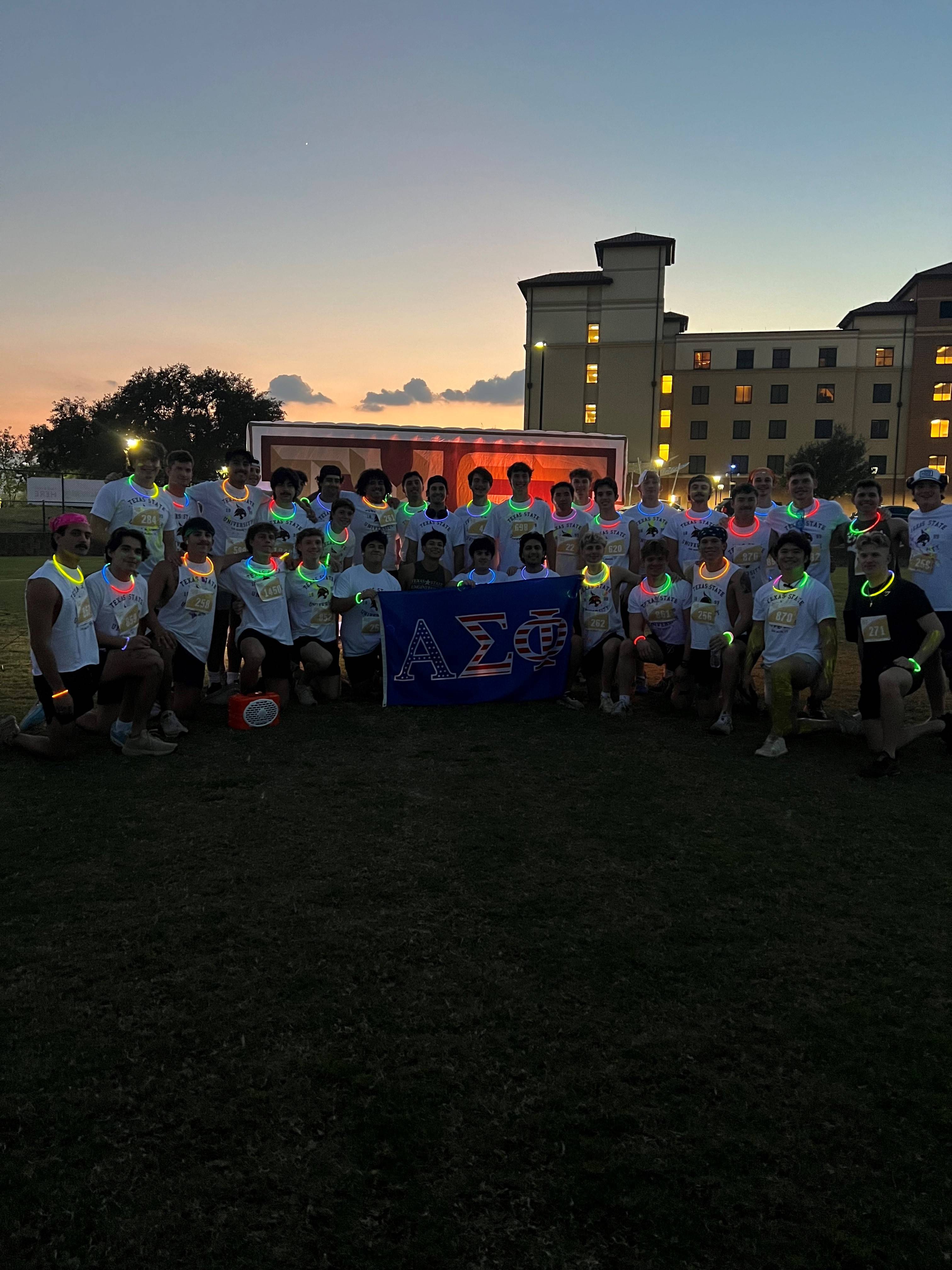 Members of Alpha Sigma Phi posing for photo at Glow Run