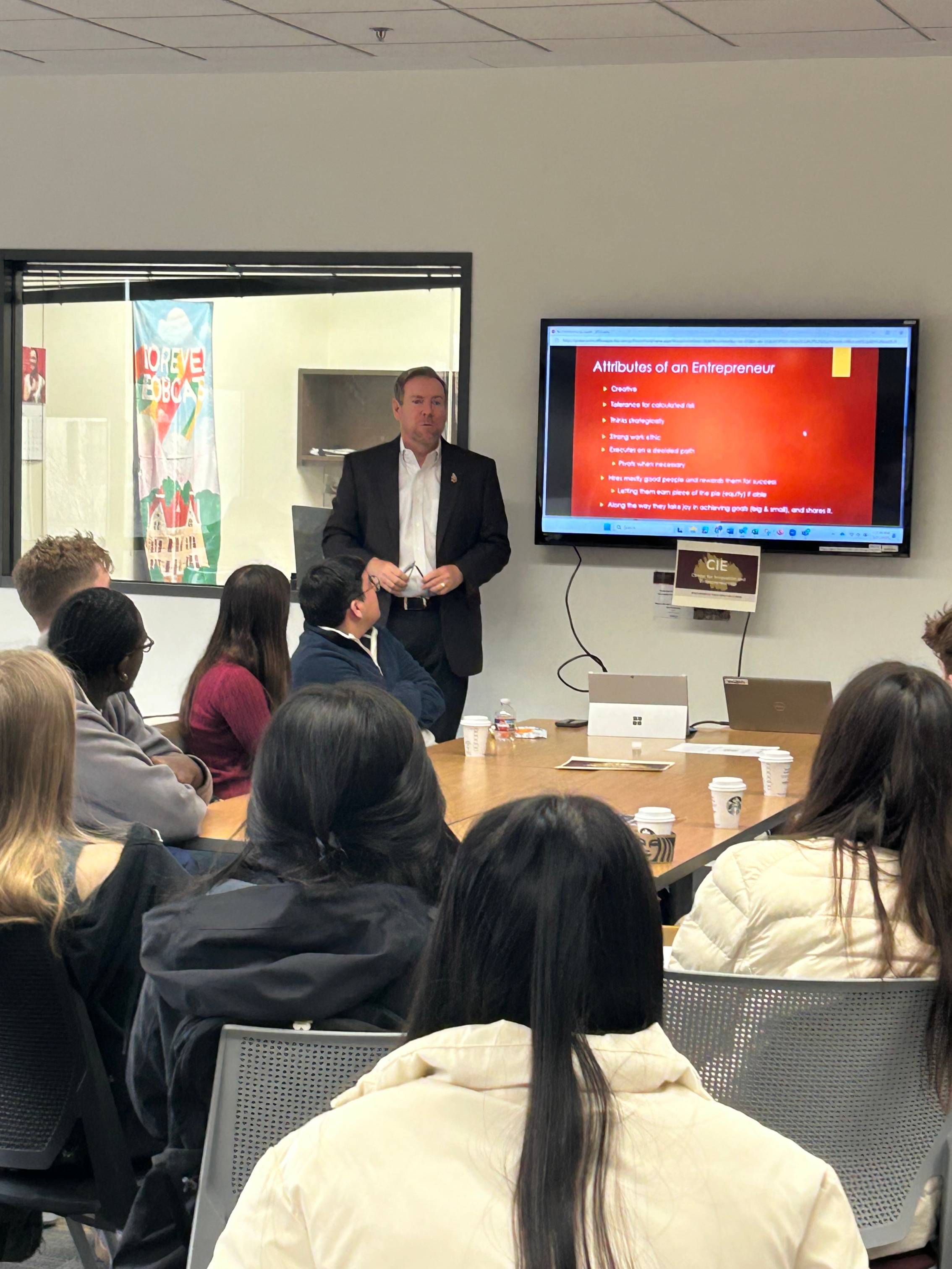 Jeff Willis speaking and presenting to students around the CIE gathering space 