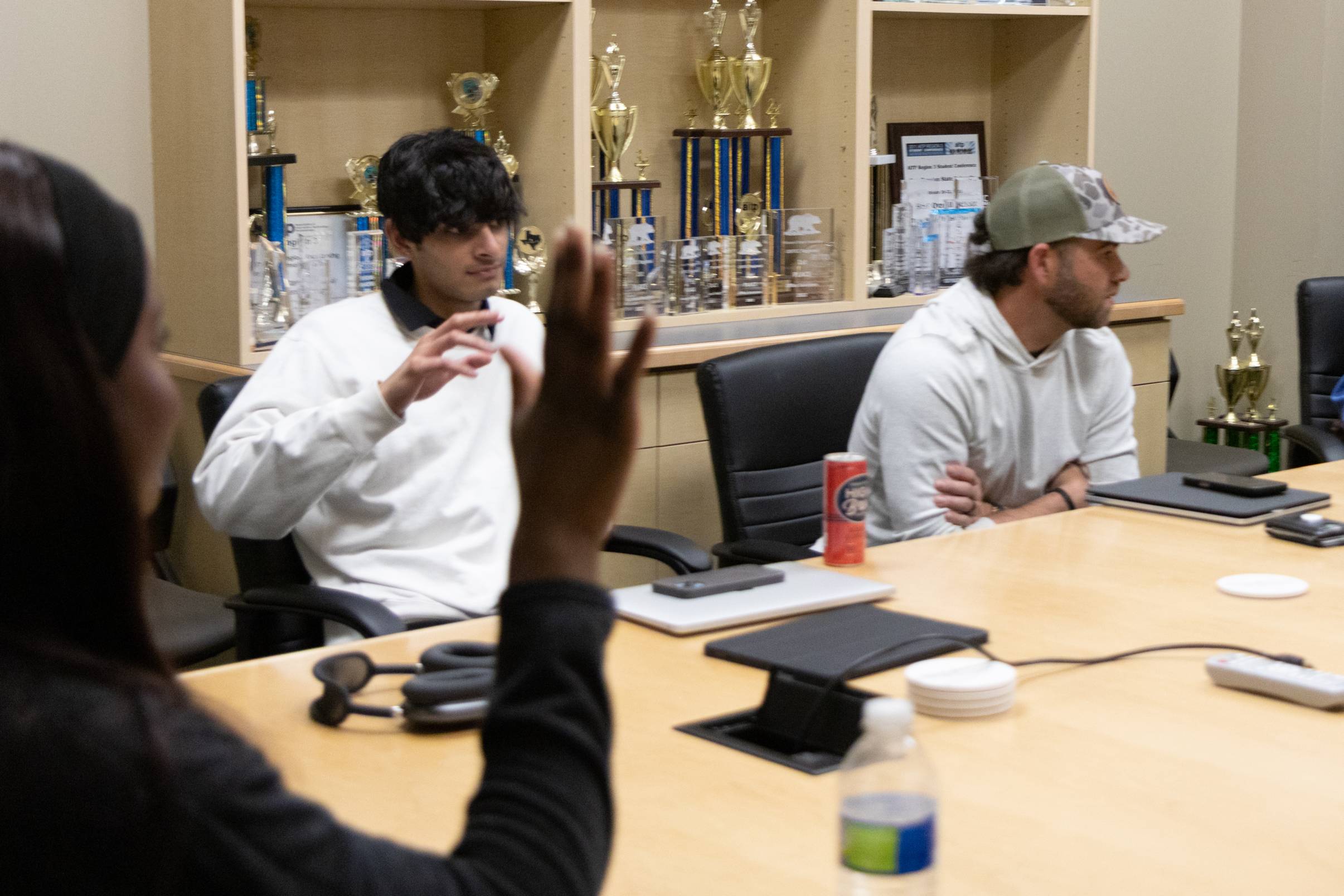 Students raising hands and being interactive during program meeting 