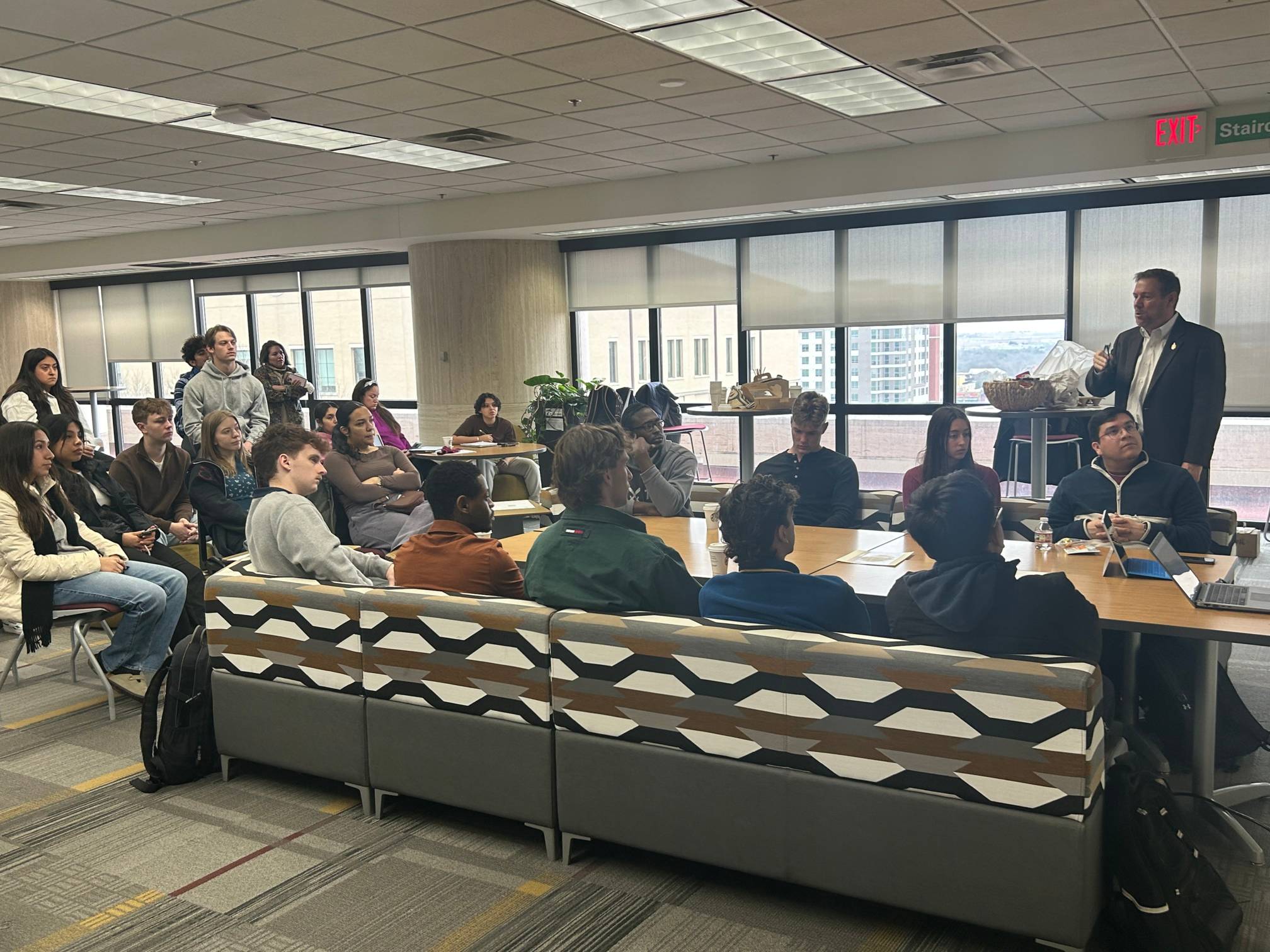 Students listening to CIE speaker series gust Jeff Willis speak around the CIE gathering space 