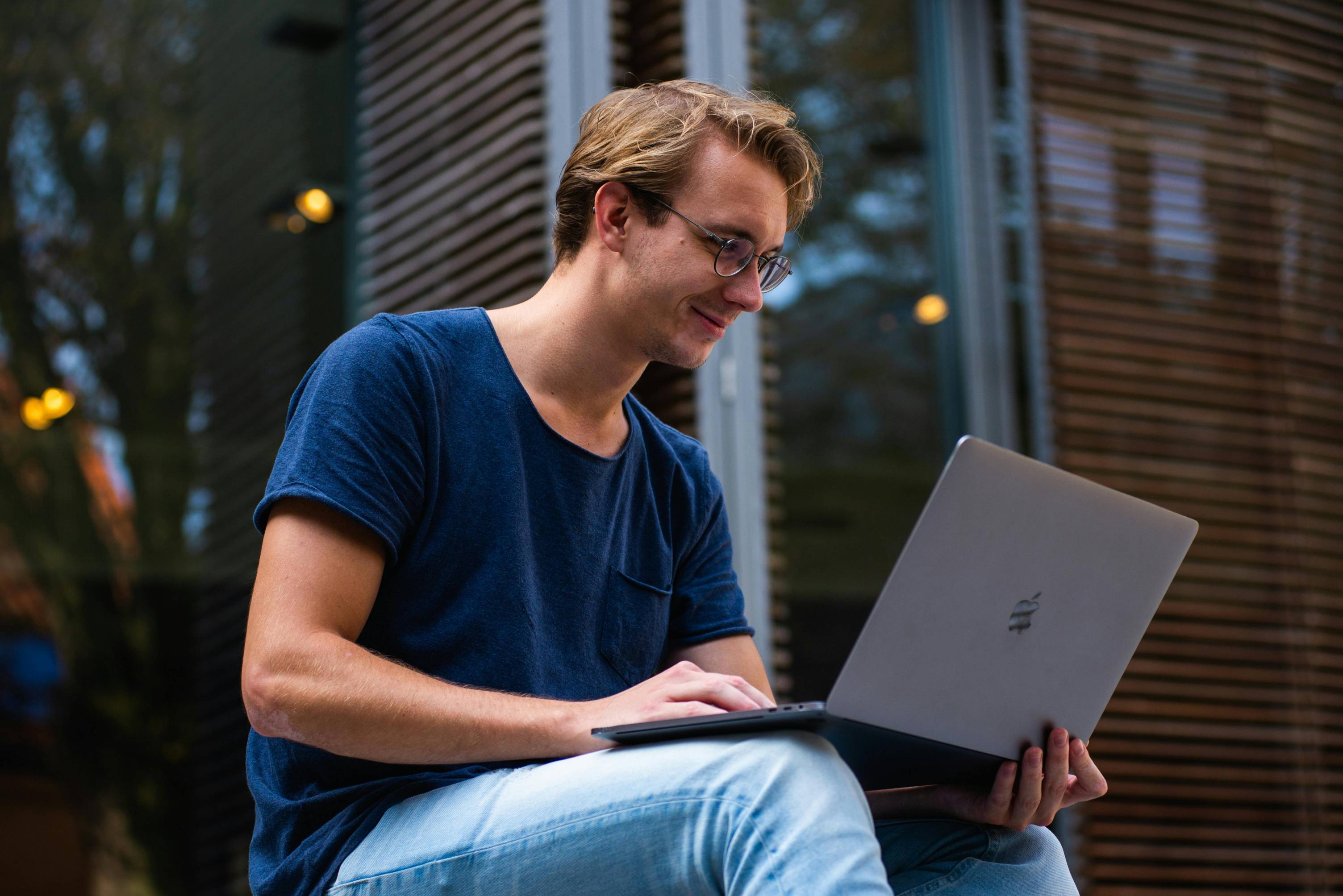 A young man on the computer outside