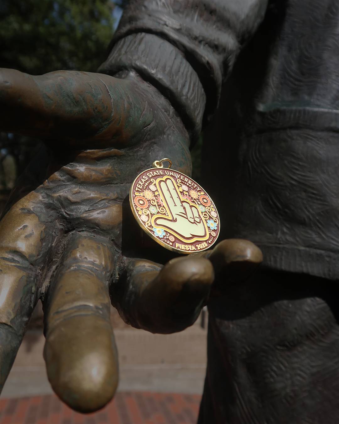 Fiesta Medal in the hand of the LBJ statue