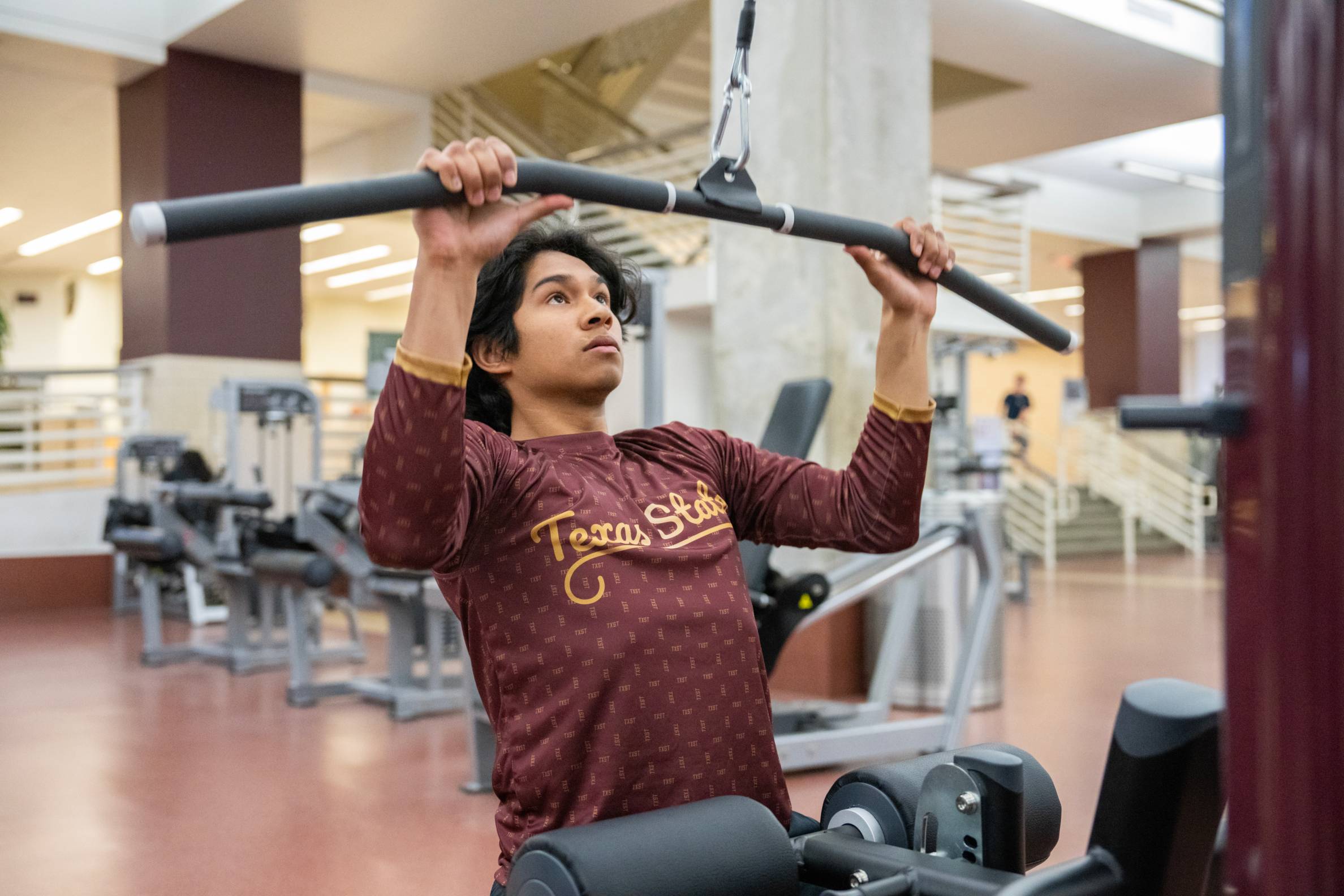 Student using the lat pull down machine