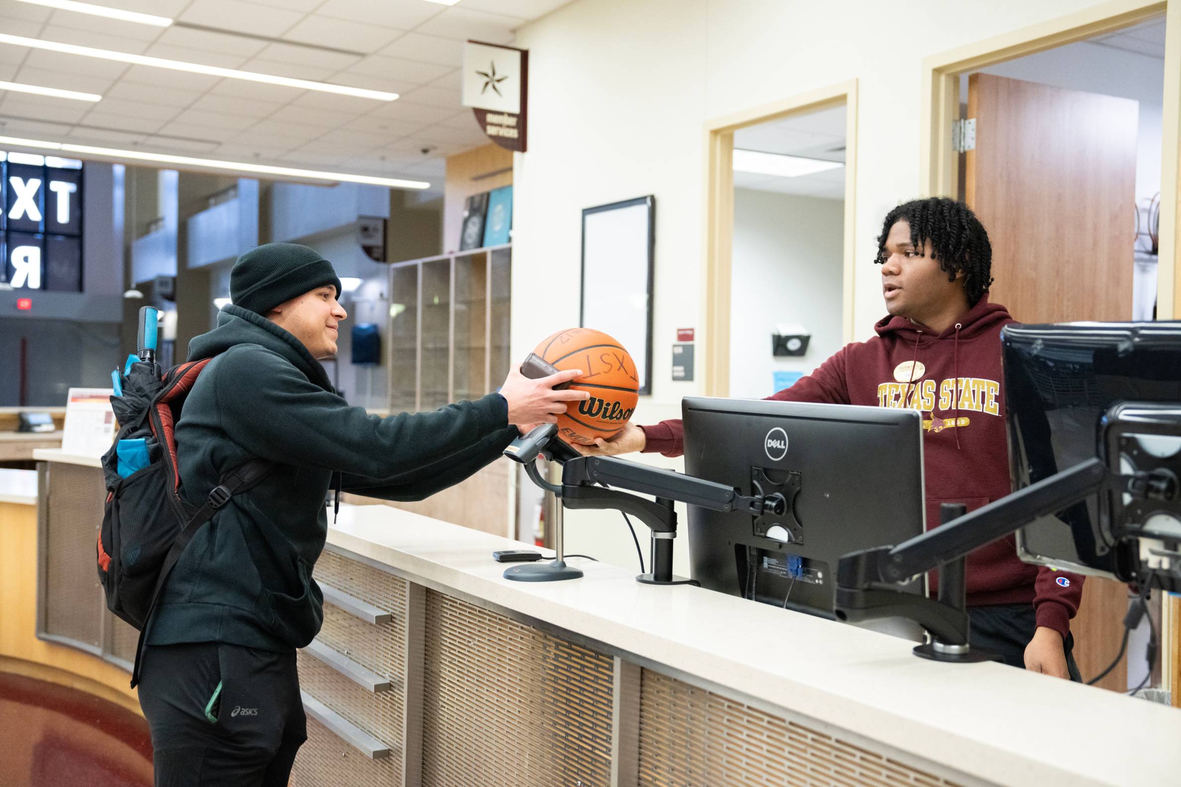 Student checking out a basketball
