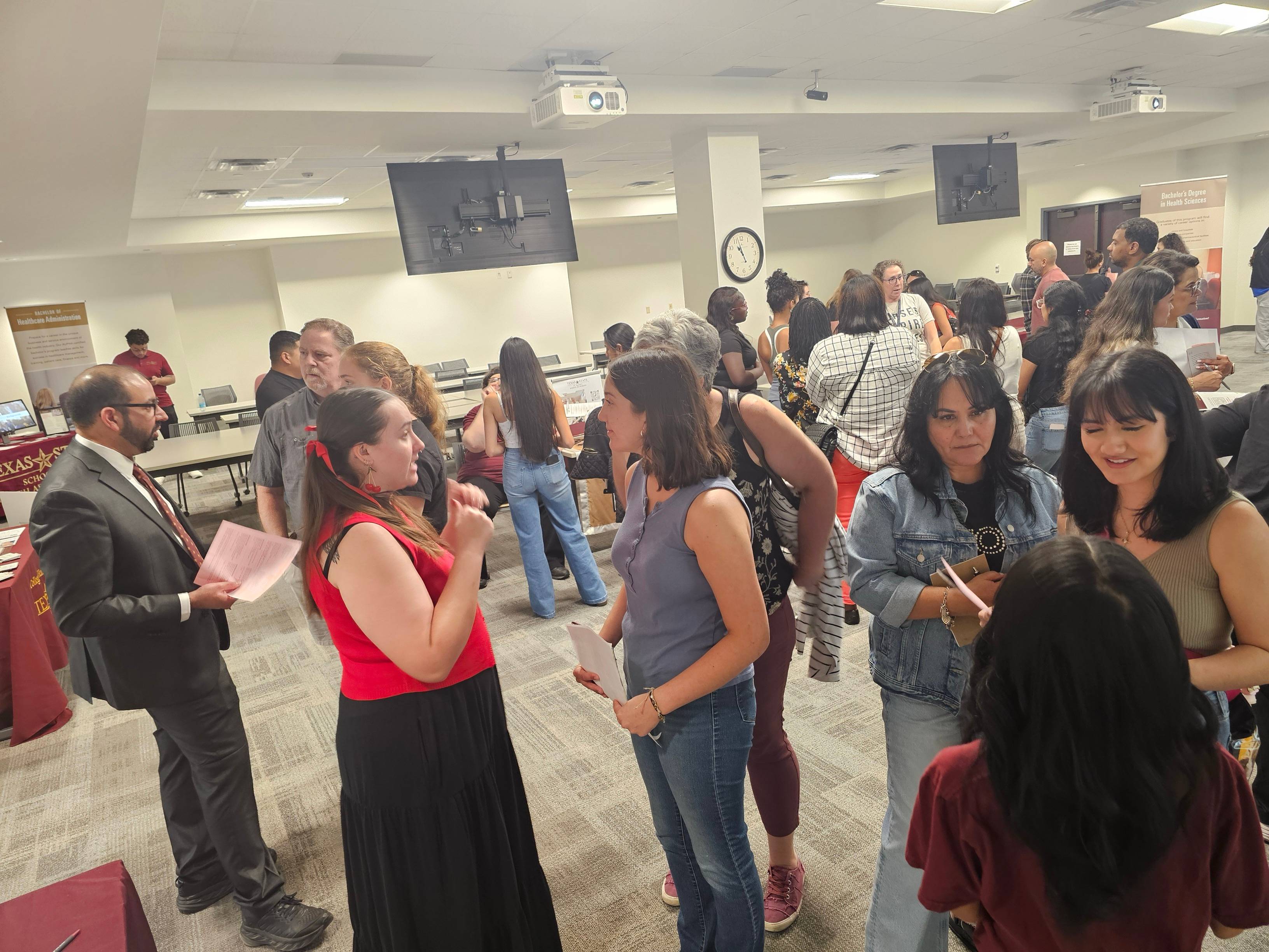 Dr. Farzan and CDIS students giving information about our program.