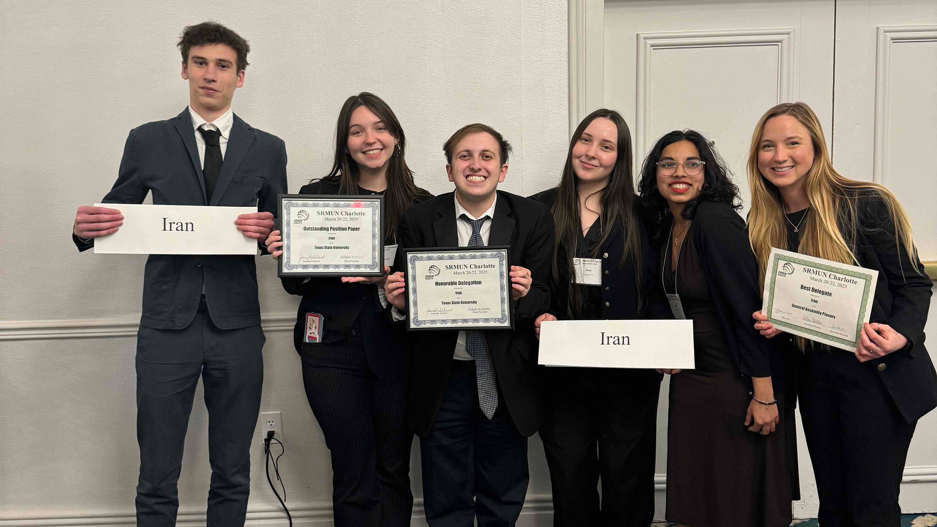 TXST students pose for a photo with their certificates at the SRMUN competition.