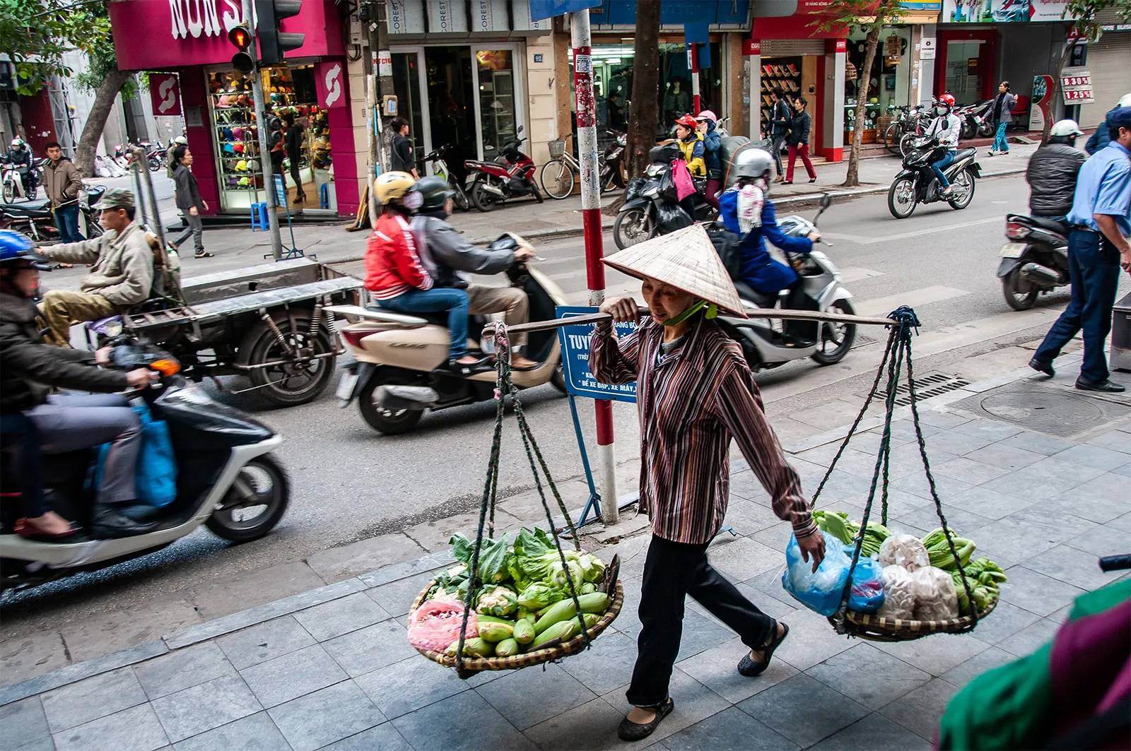 Man in Vietnam carrying fruit