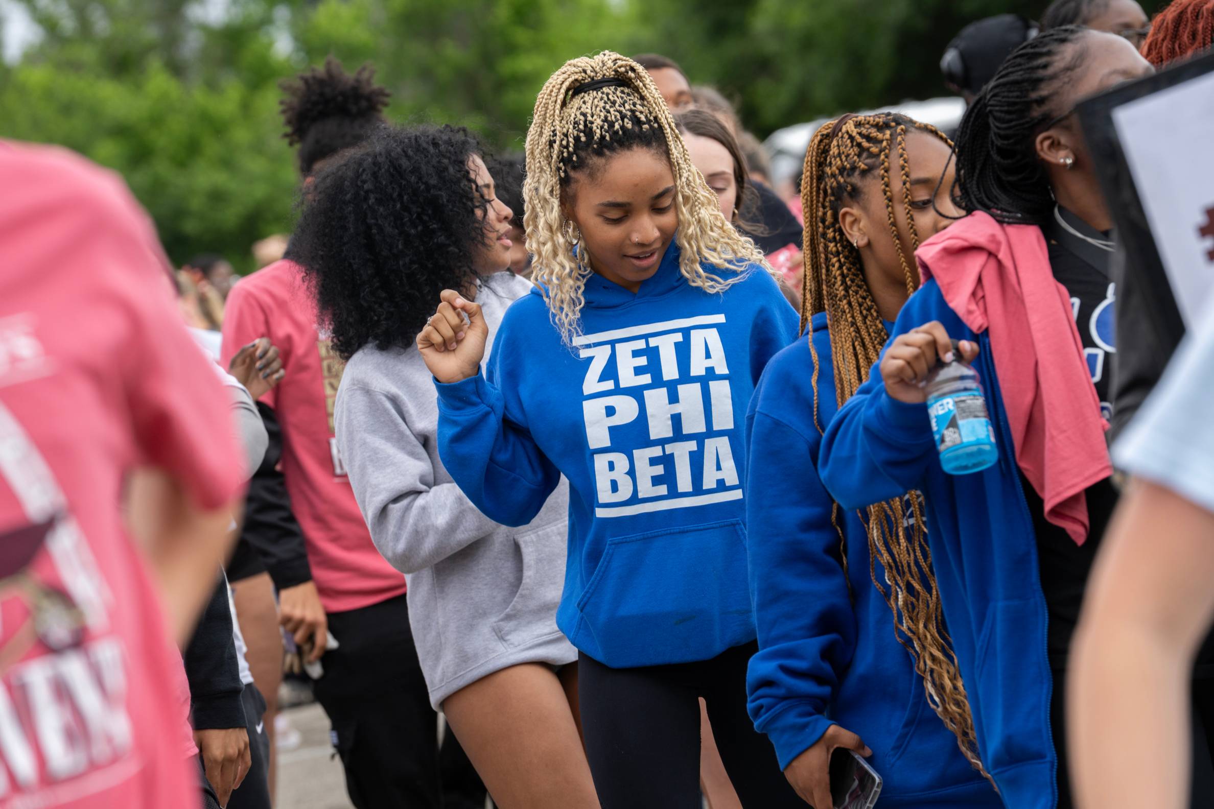 Woman dancing in a blue hoodie
