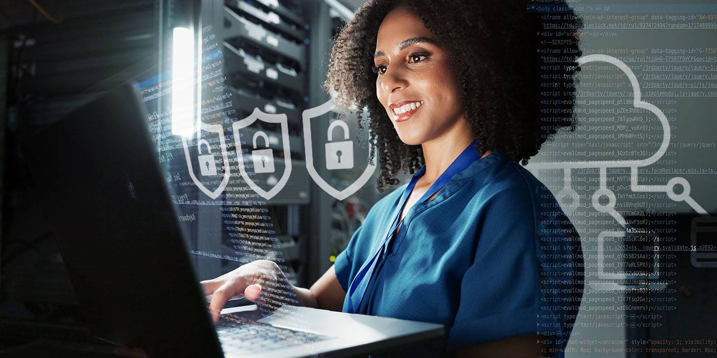 a smiling woman typing on laptop
