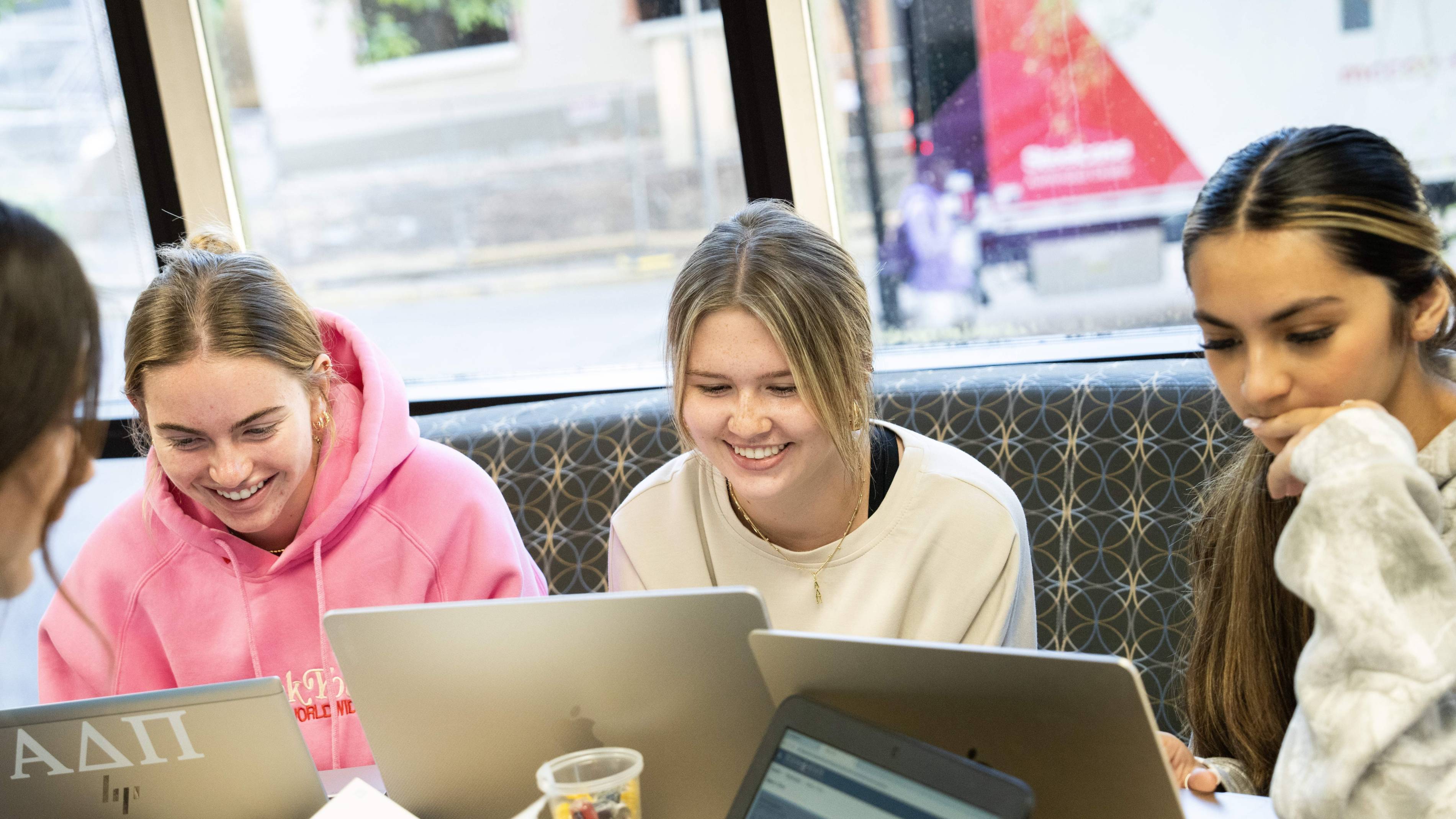 Female students studying with laptops