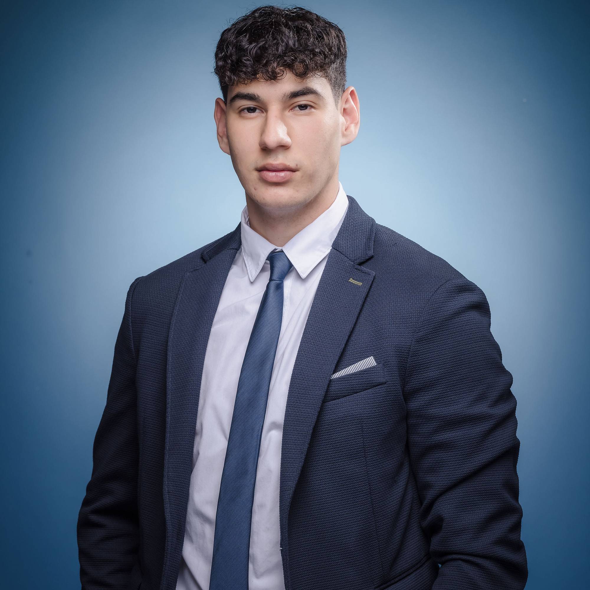 student dressed in professional attire poses for headshot photo