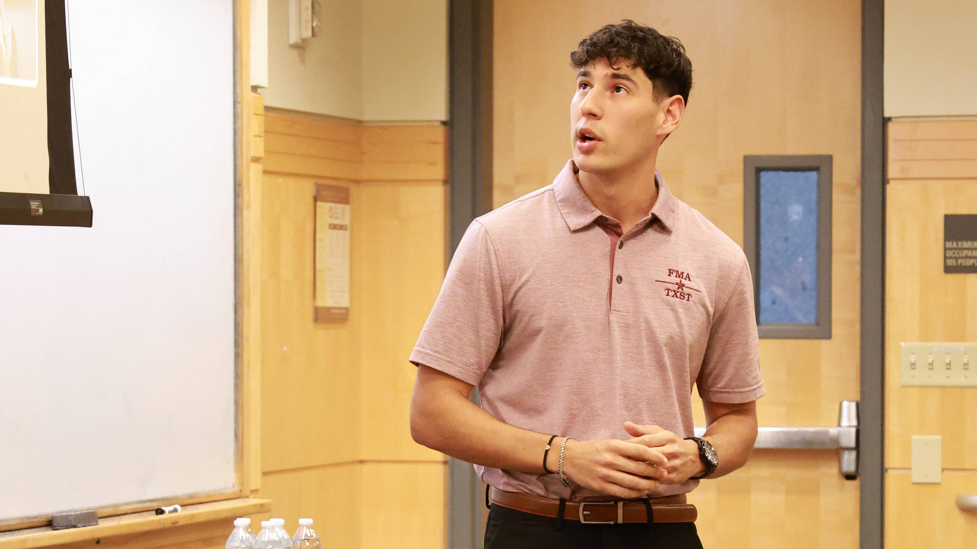 student speaking in front of classroom