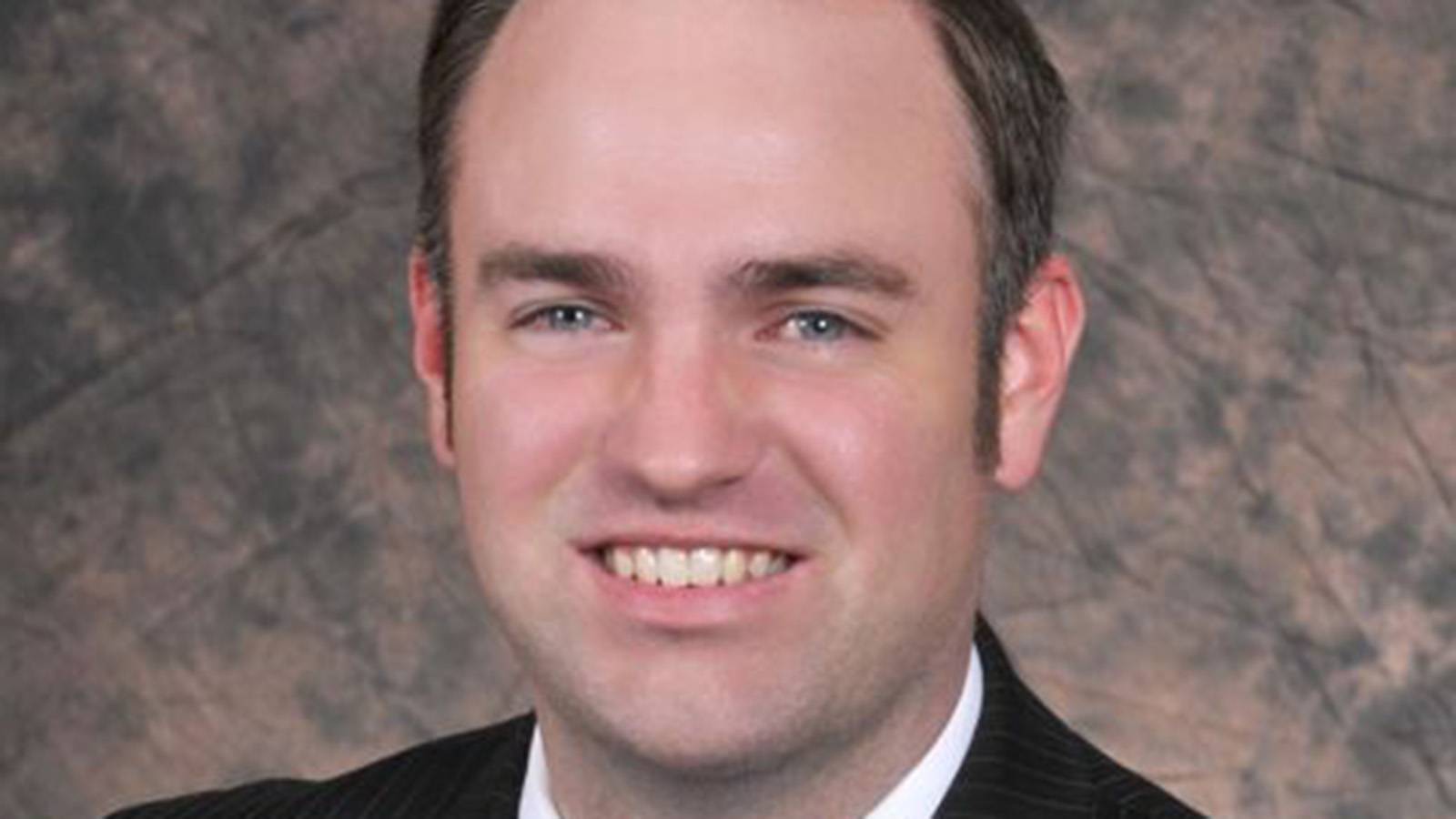 Christopher Proschko smiling in headshot photo