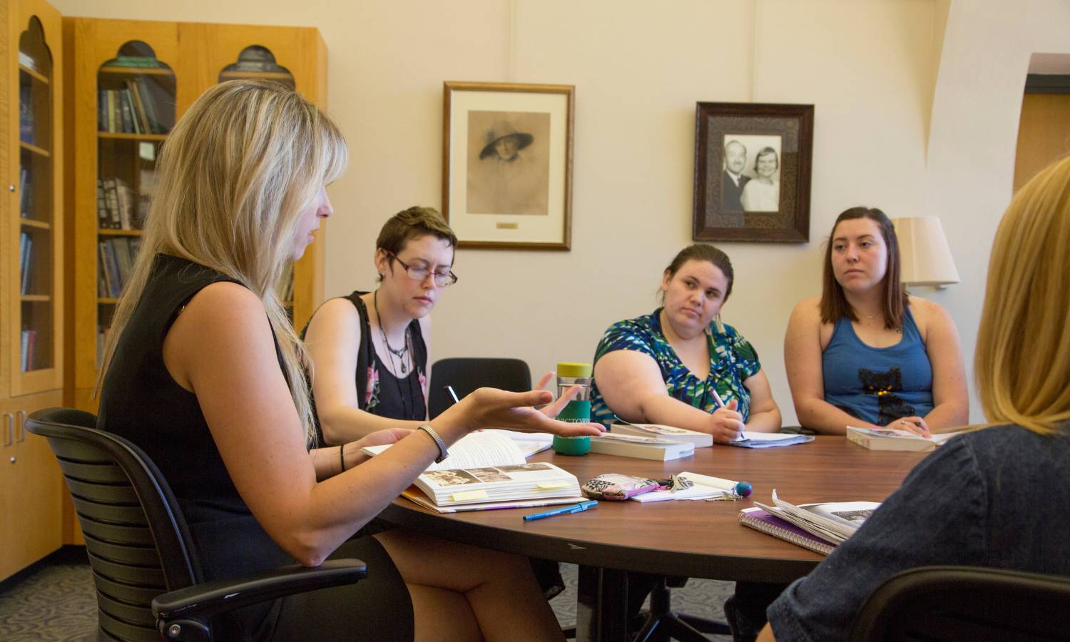 A professor speaking to a small group of students