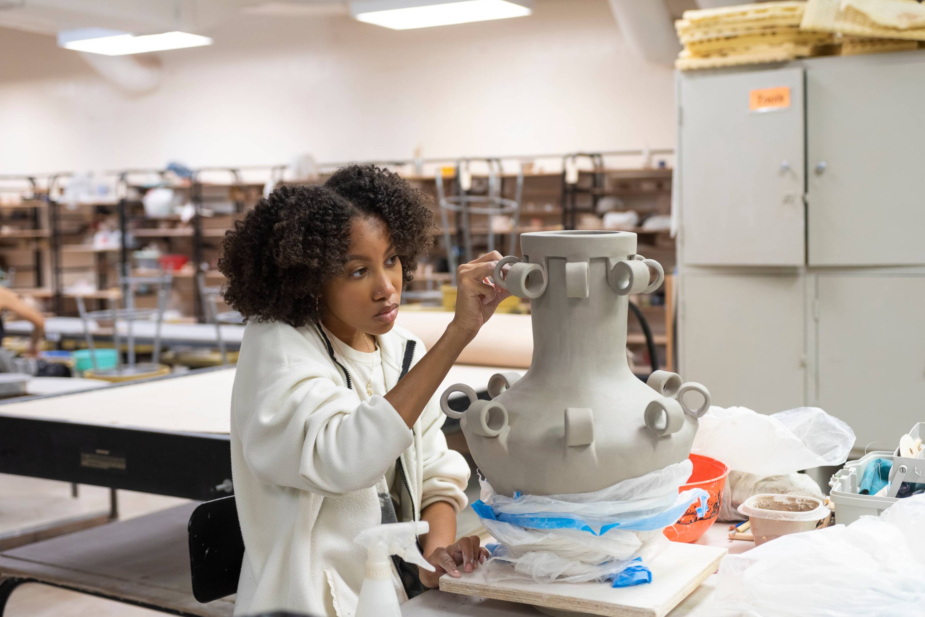 in a art studio where a student is designing a vase