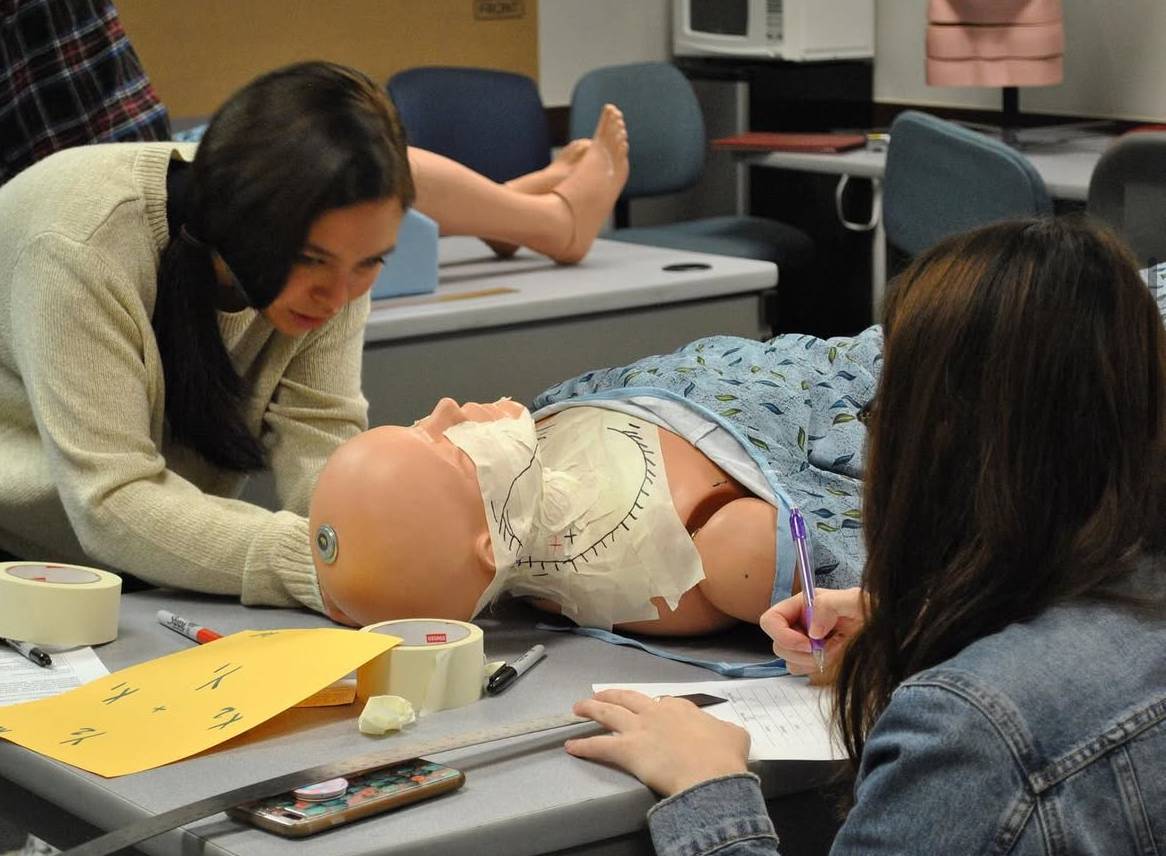 Students practicing patient positioning in the simulation lab.