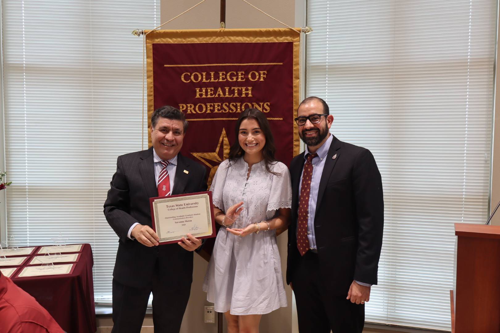 CDIS student Savanna Slaton received the Outstanding Academic Graduate Student award from Dr. Sayed and Dr. Irani
