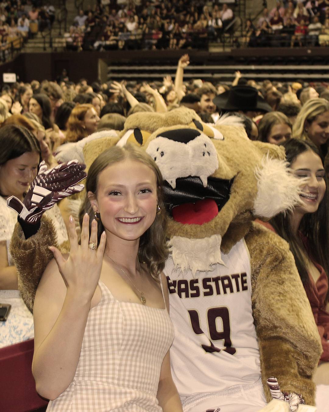 Student smiling with their ring sitting next to Boko