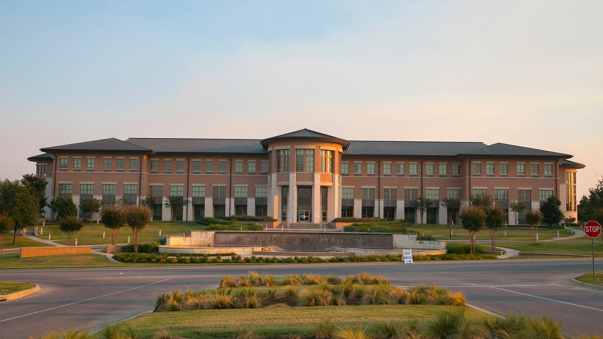 the sun setting on a college academic buidling