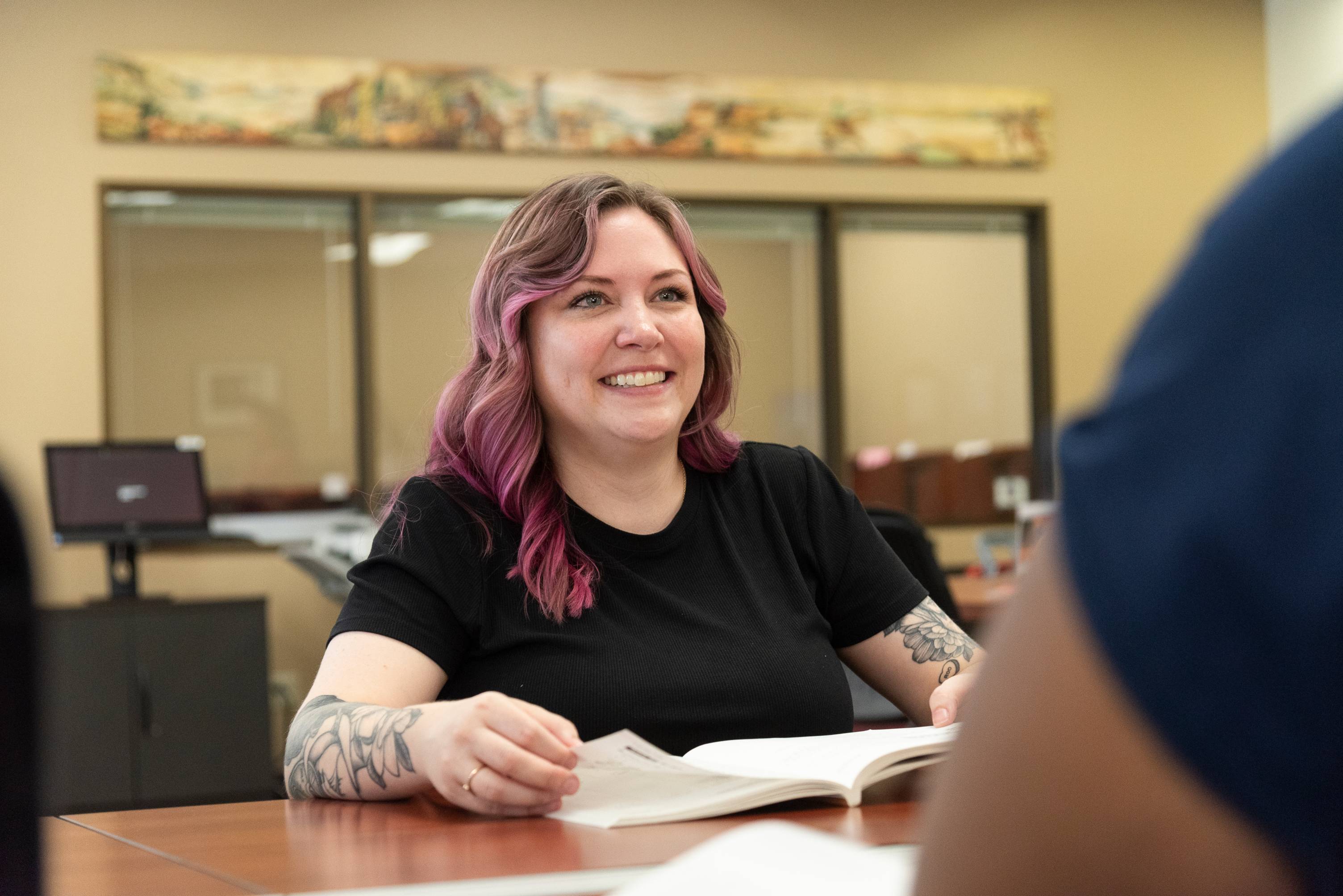 Picture of student with pink hair smiling