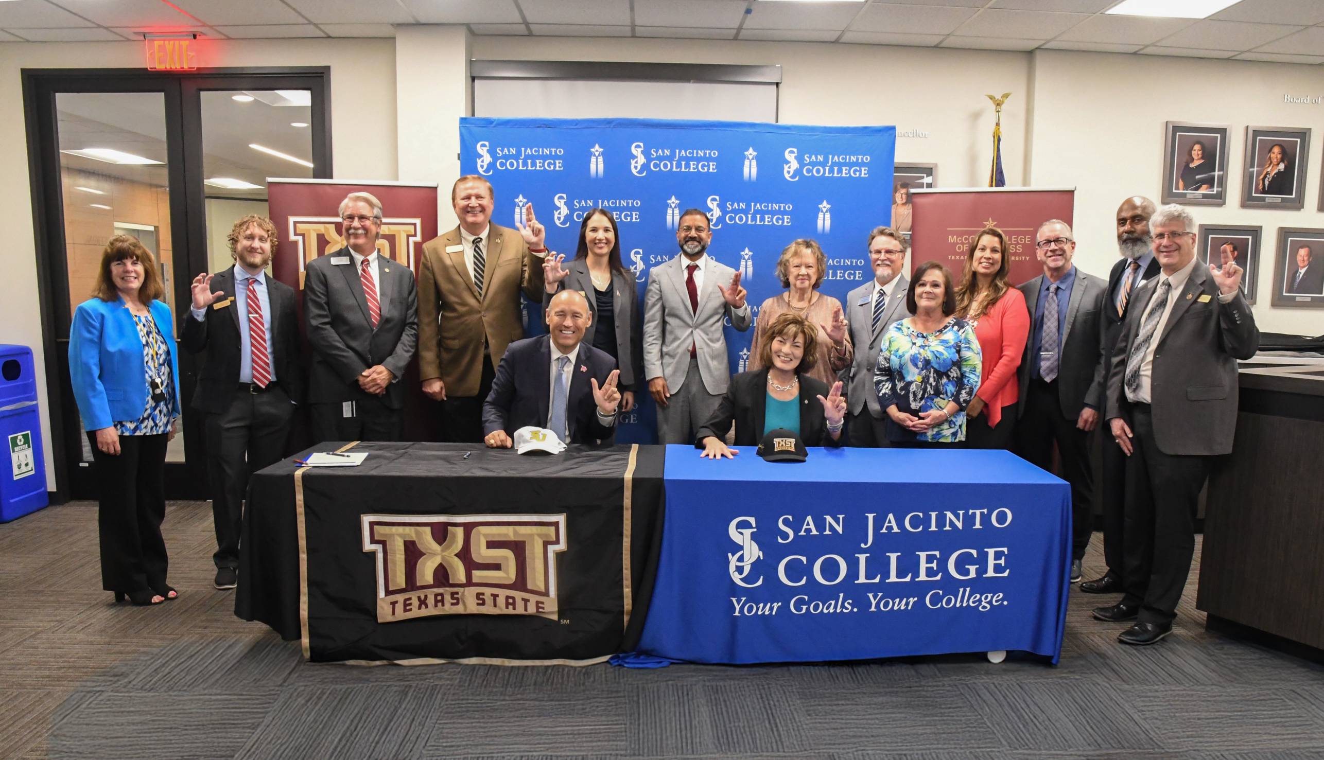 university leaders pose for a group photo at a signing ceremony