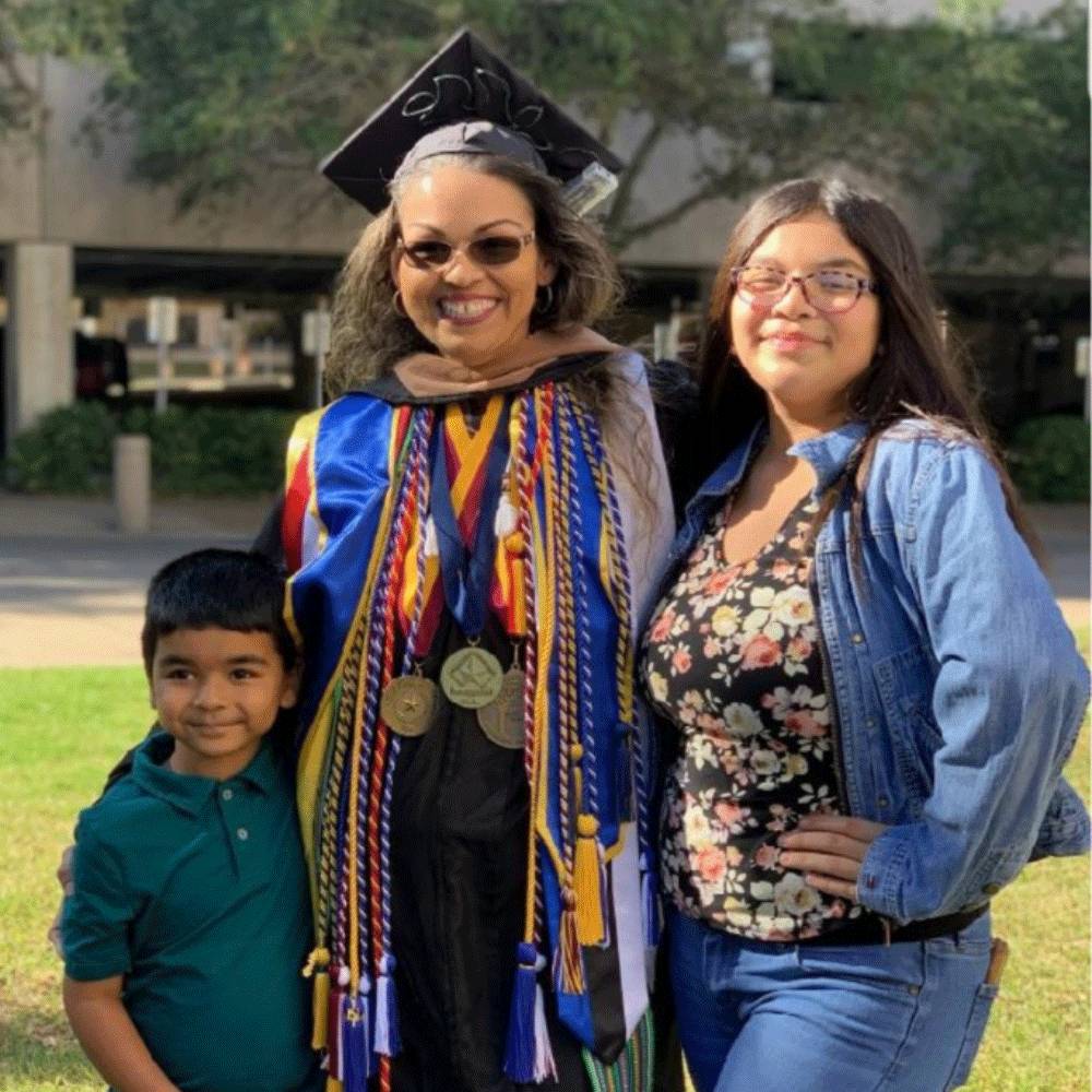 Jessica Ramos-Karmaker with her family after a commencement ceremony