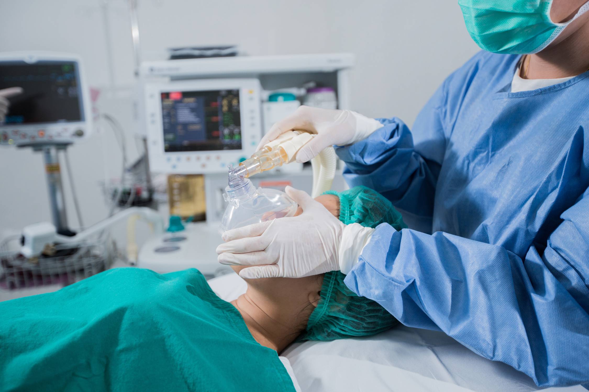 Doctor putting patient under anesthesia. 
