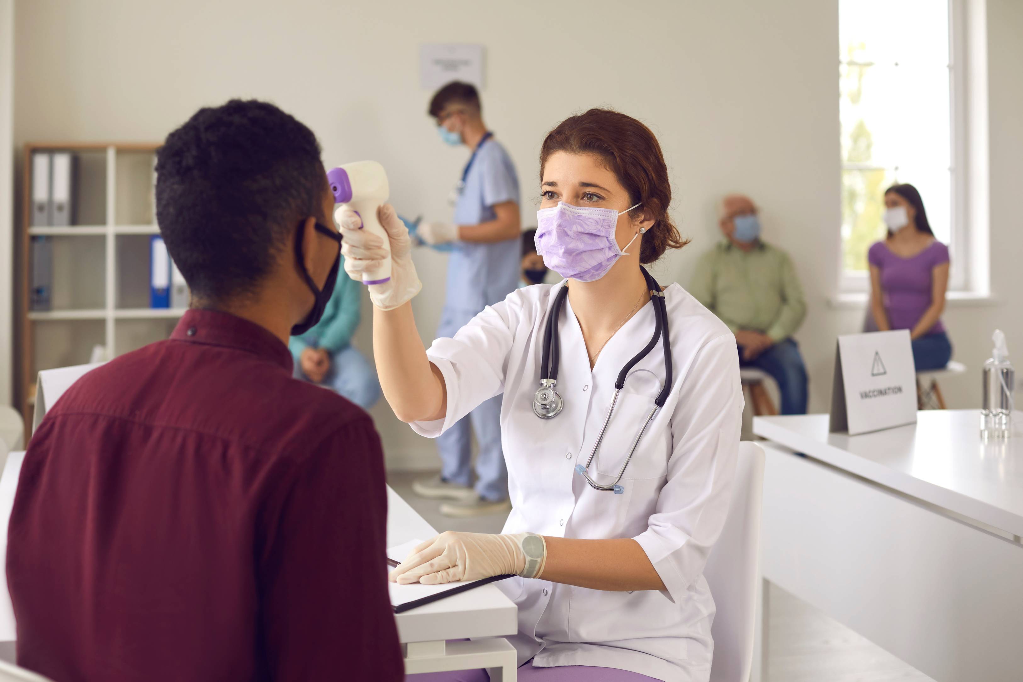Doctor taking patients temperature. 