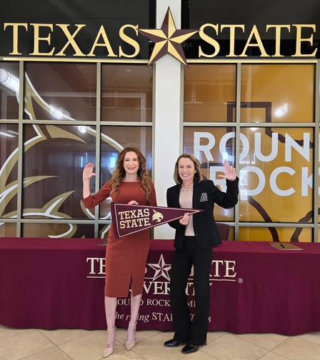 two people shaking hands at a signing ceremony