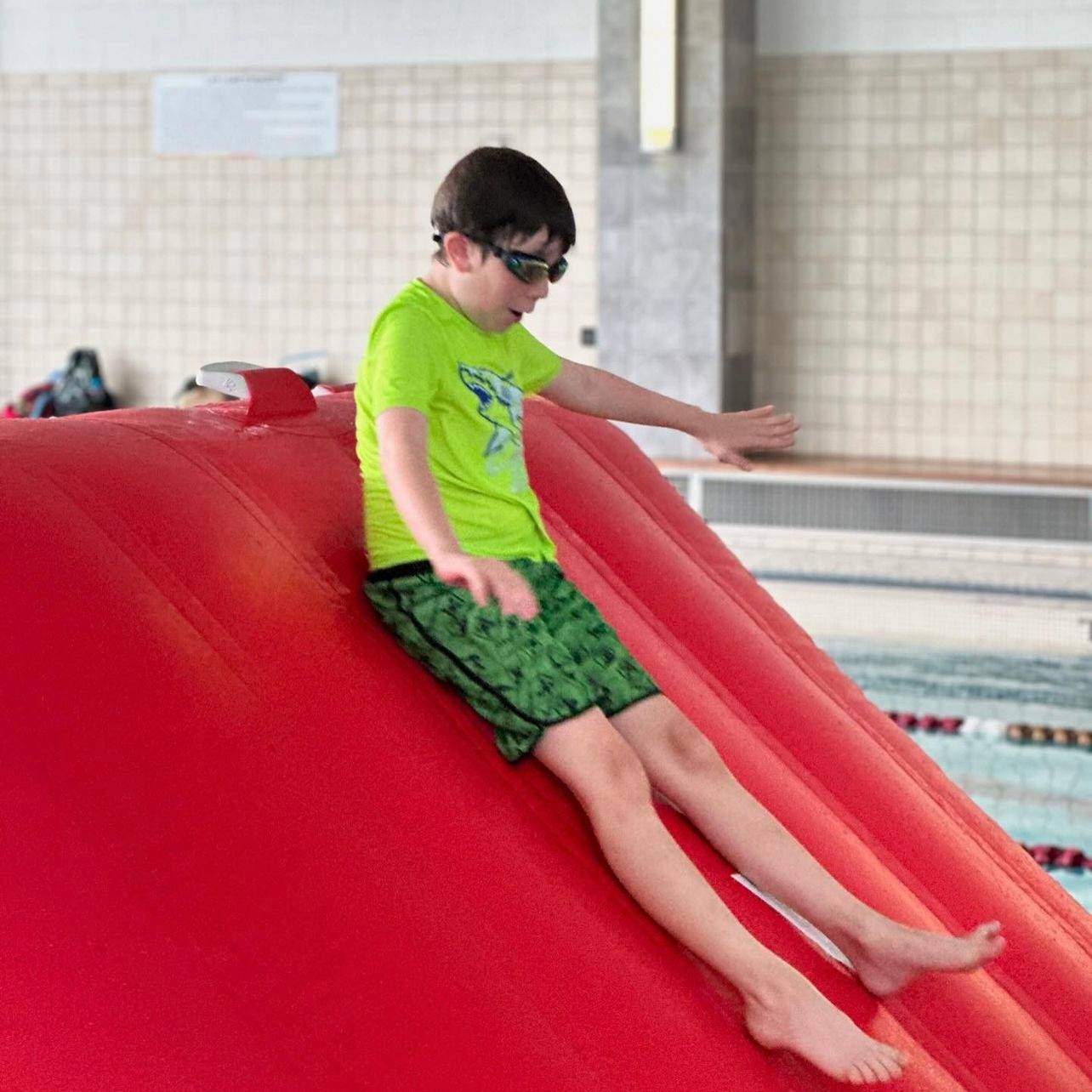 child sliding down waterslide