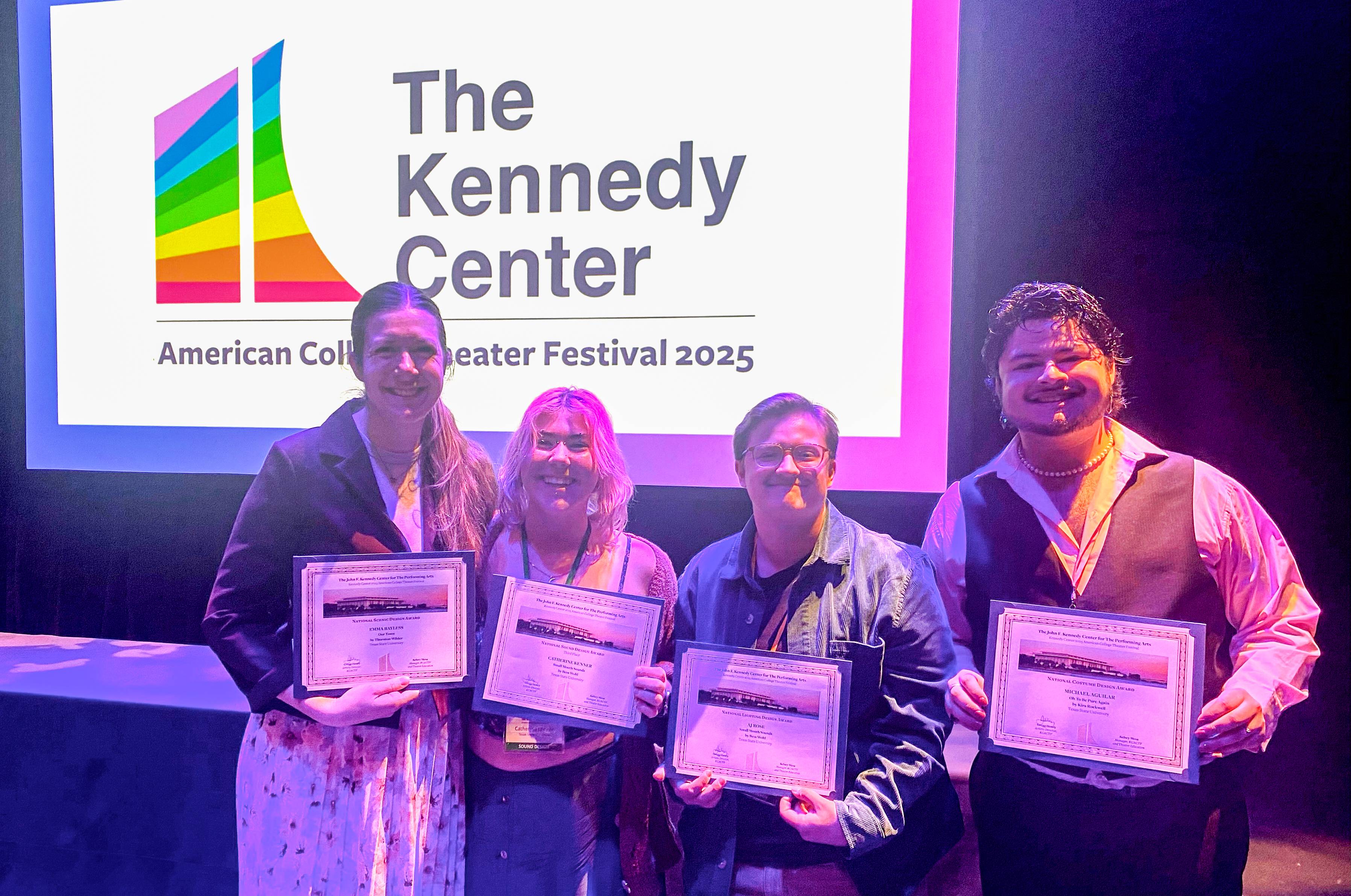 students holding certificates at a showcase
