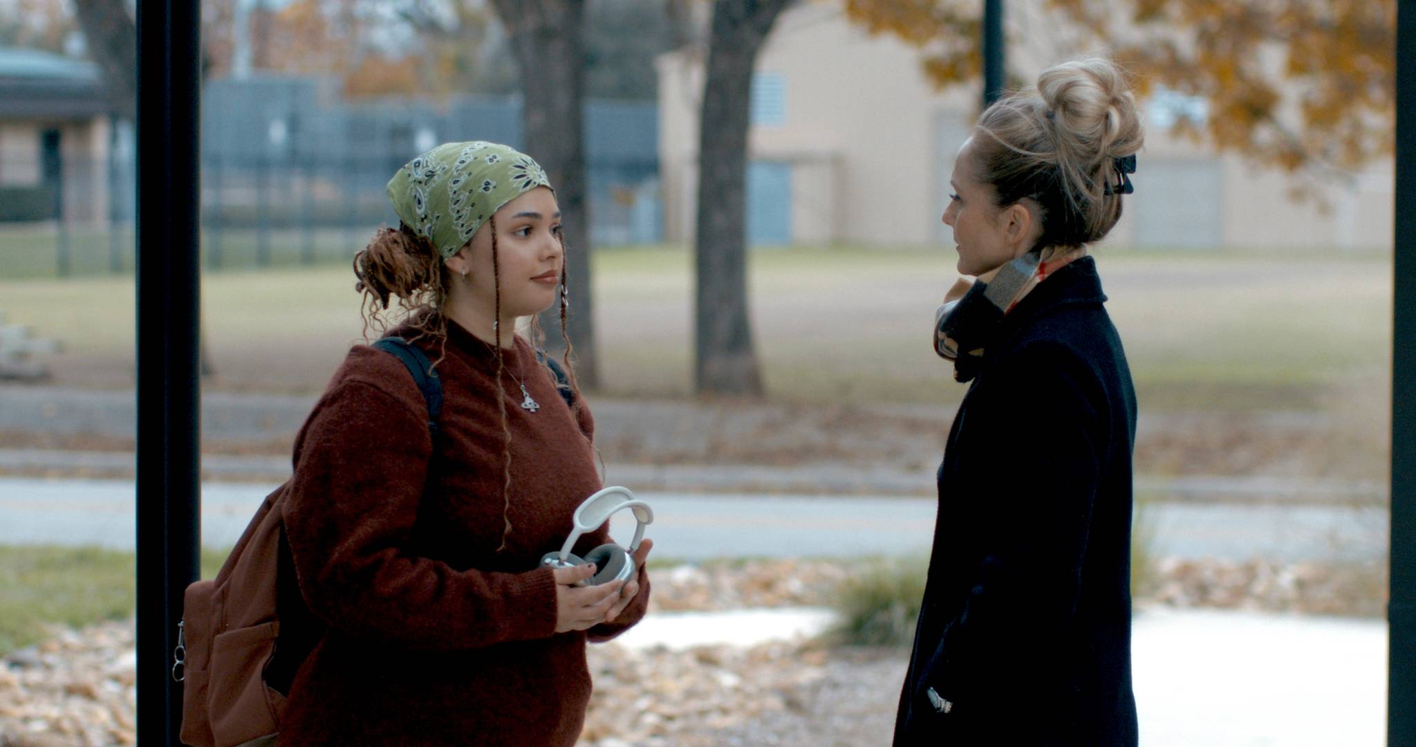 two actresses talking to each other in a movie scene