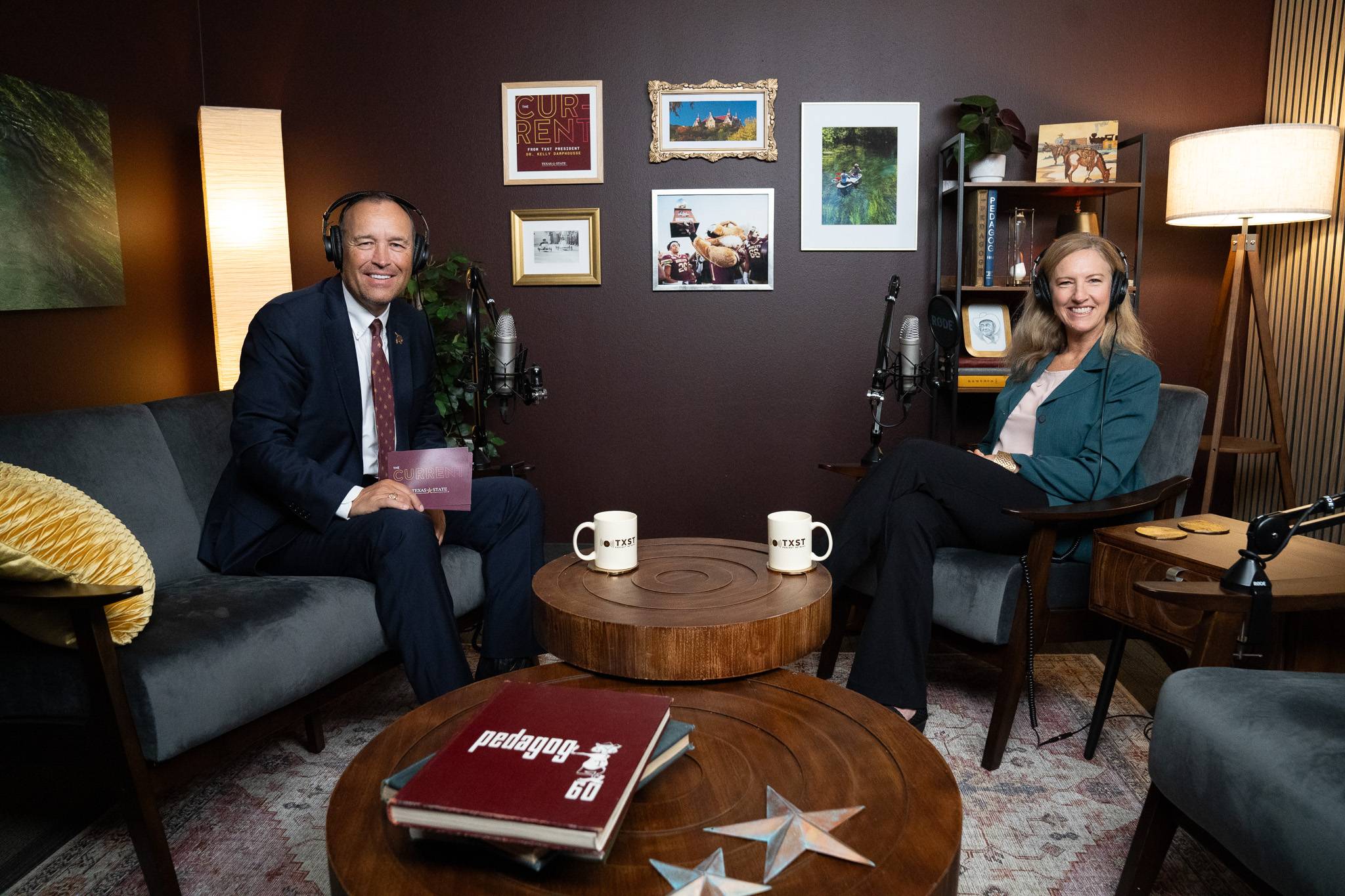 man and woman sitting in podcast studio and smile for a photo