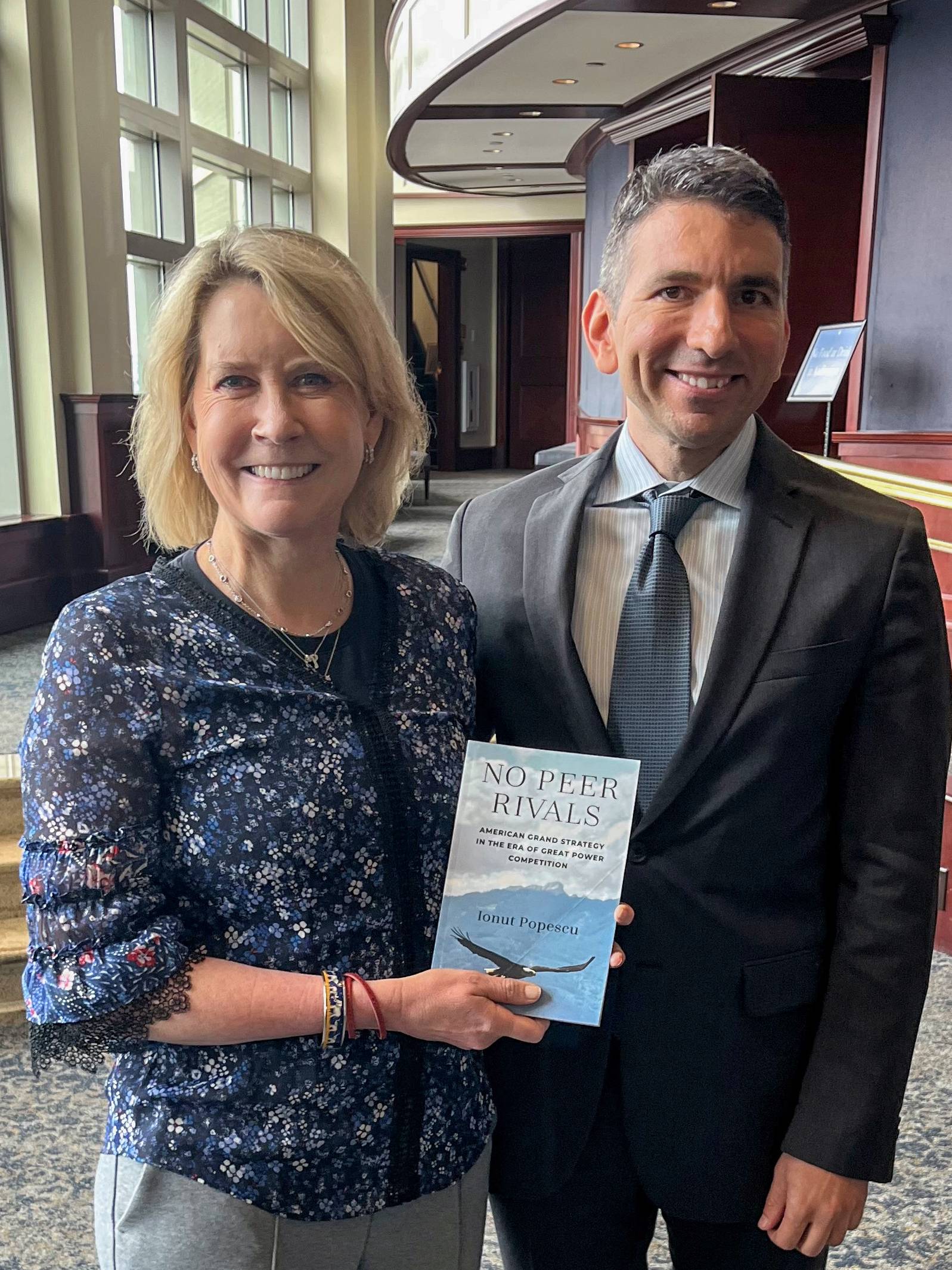 two people holding a book