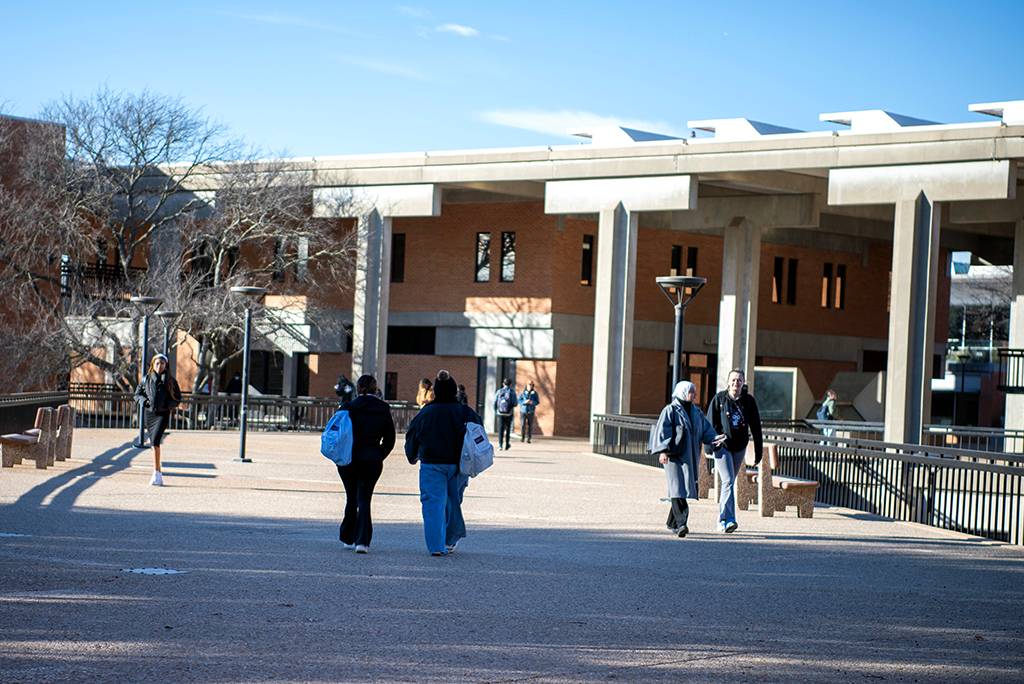 exterior of campus building with students walking past