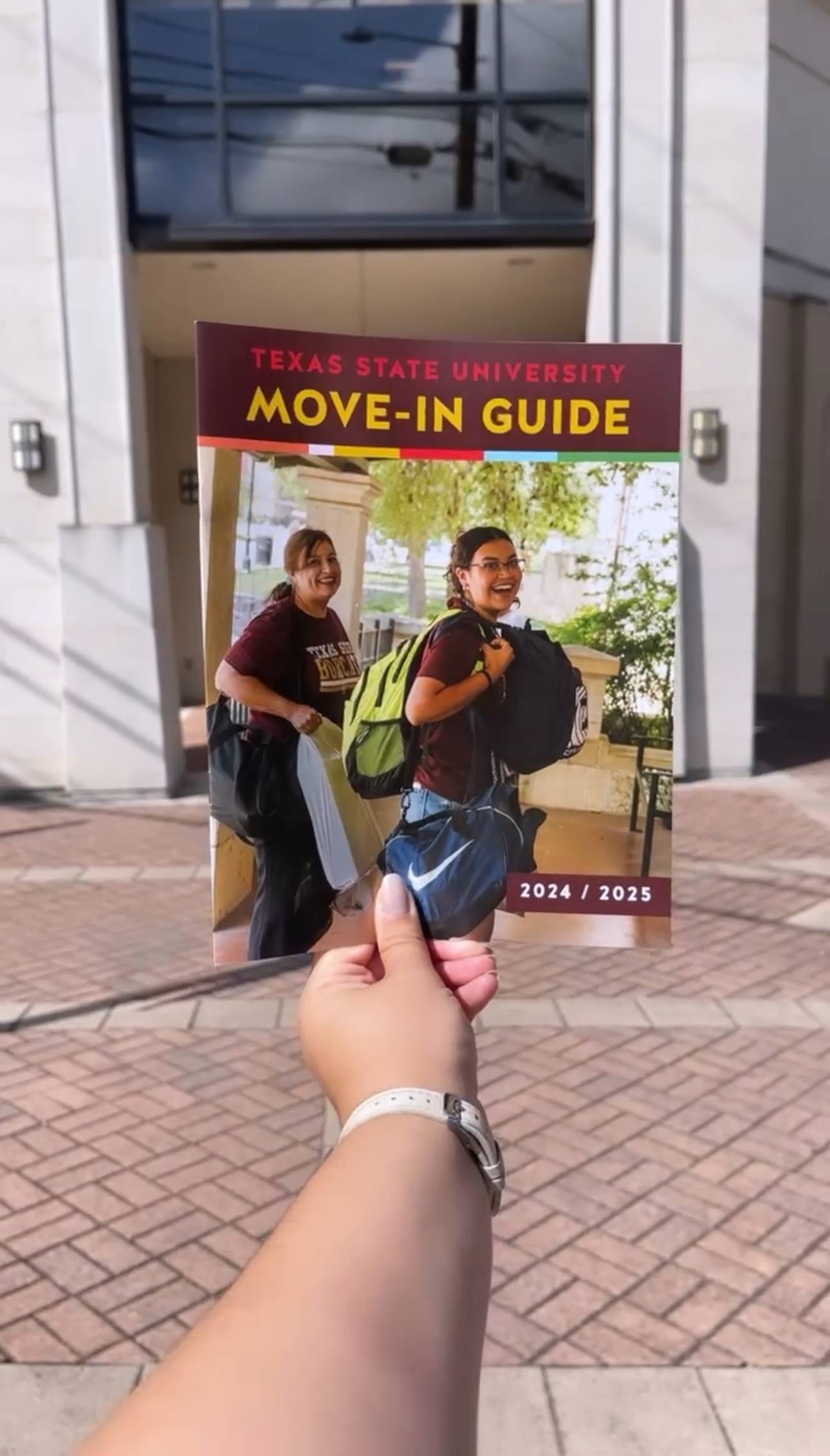 hand holding a booklet
