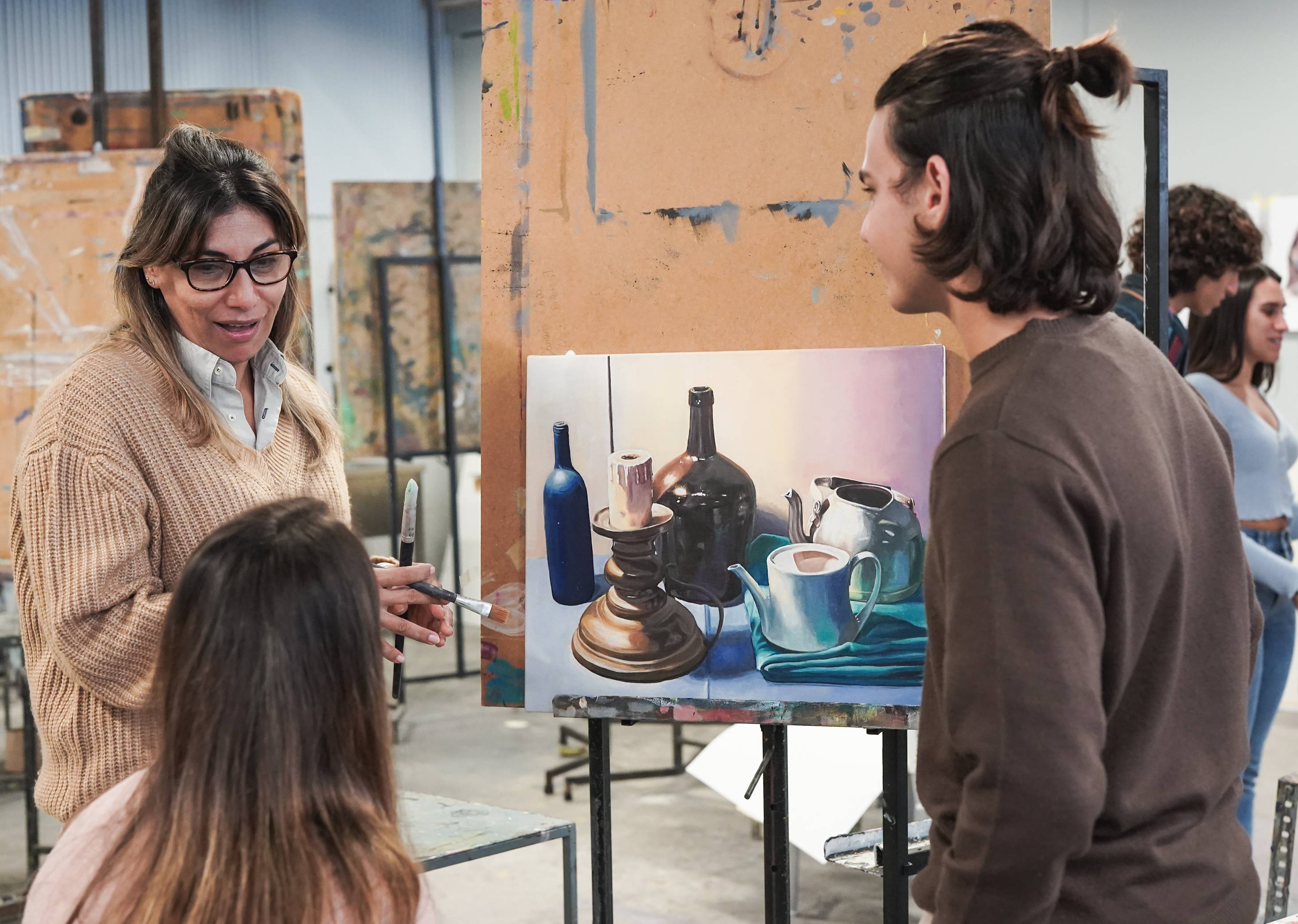 an art teacher reviewing a painting