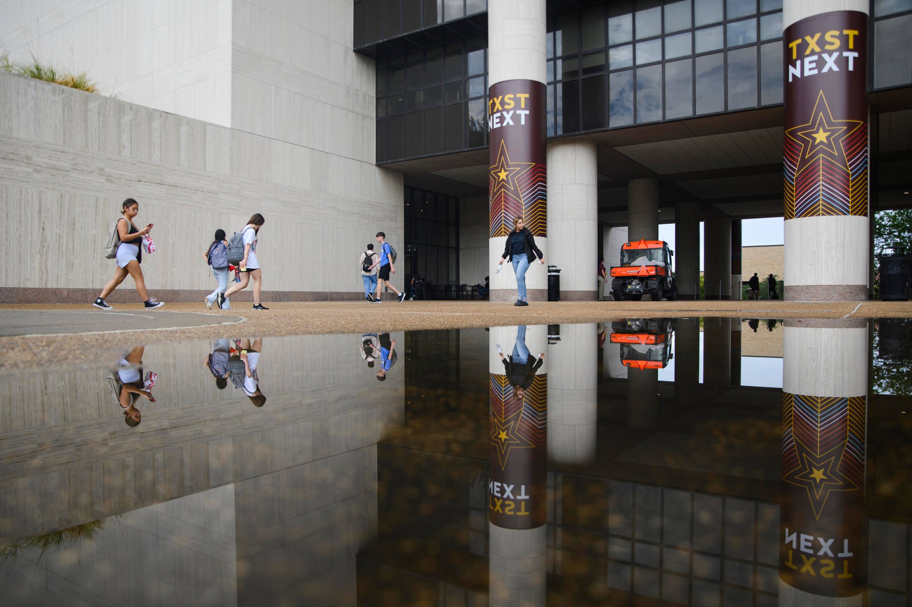Alkek Library with puddle mirror view