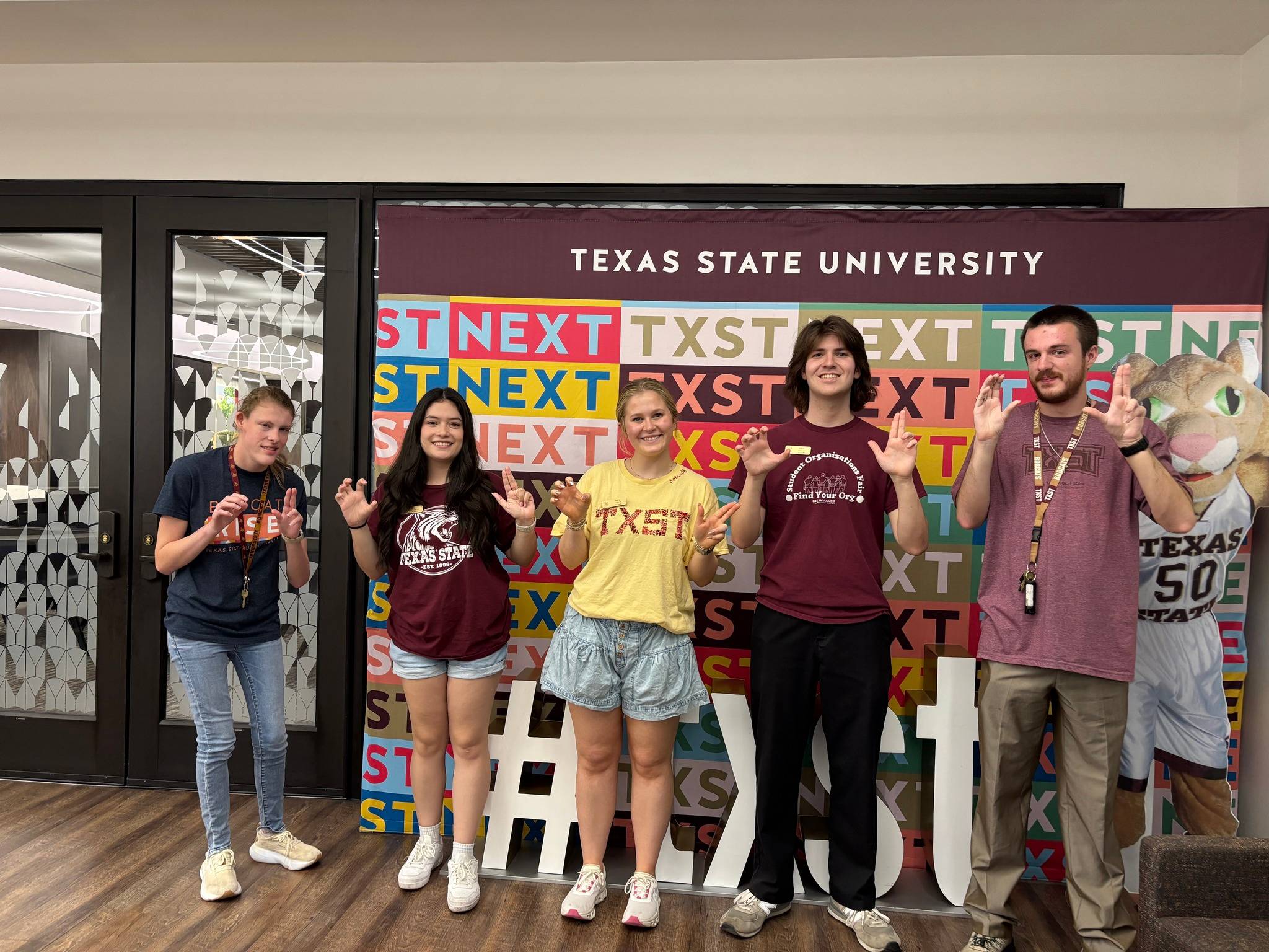five students in front of txst next step and repeat