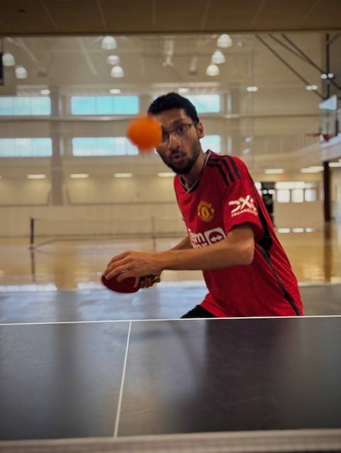 student about to hit a table tennis ball