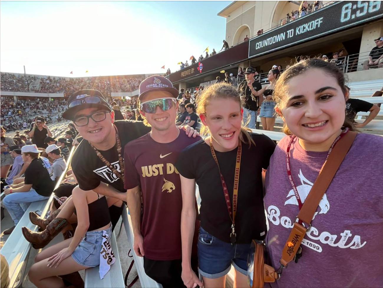 four students at football game