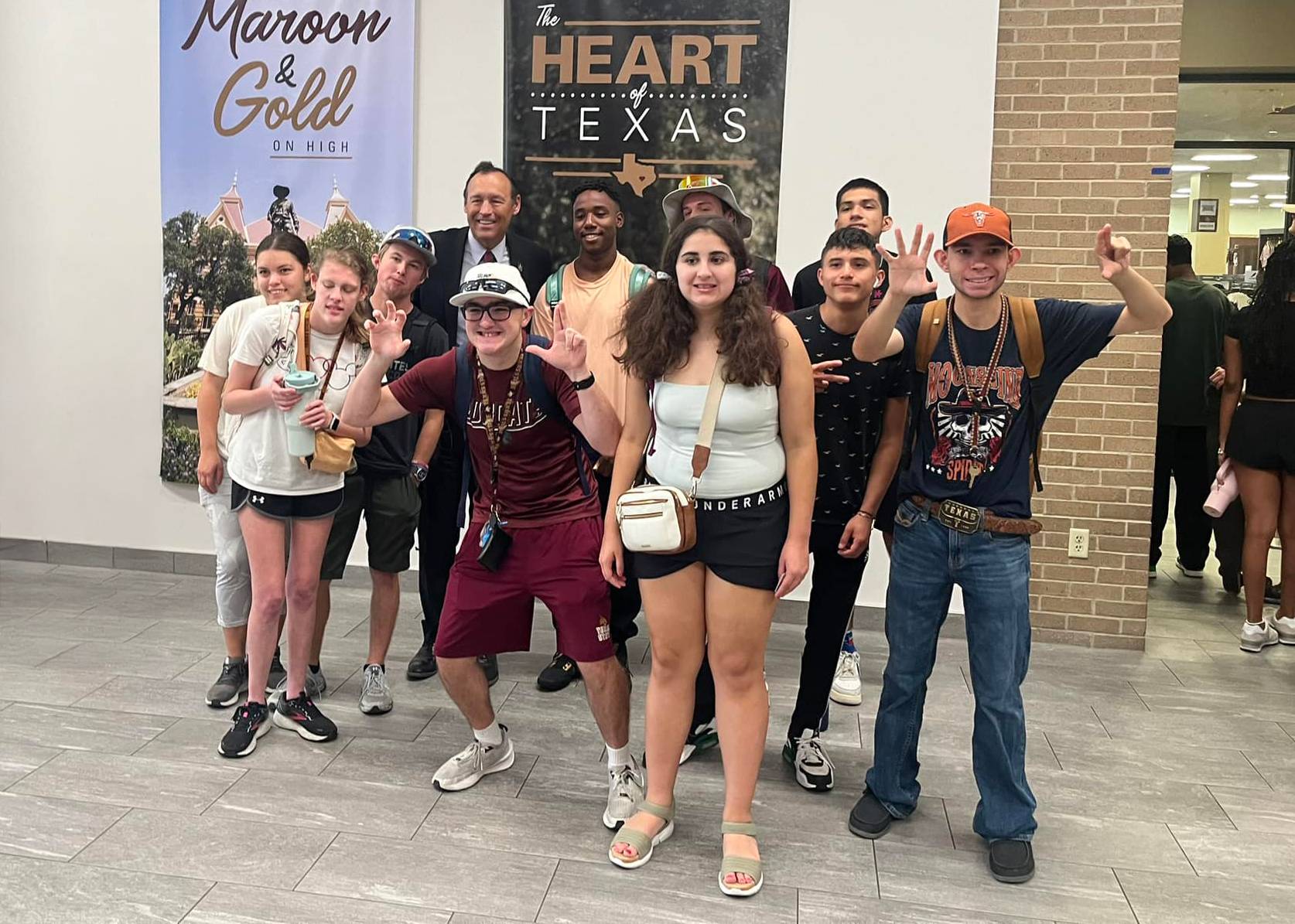 large group of bobcat RISE students pose with President Damphousse