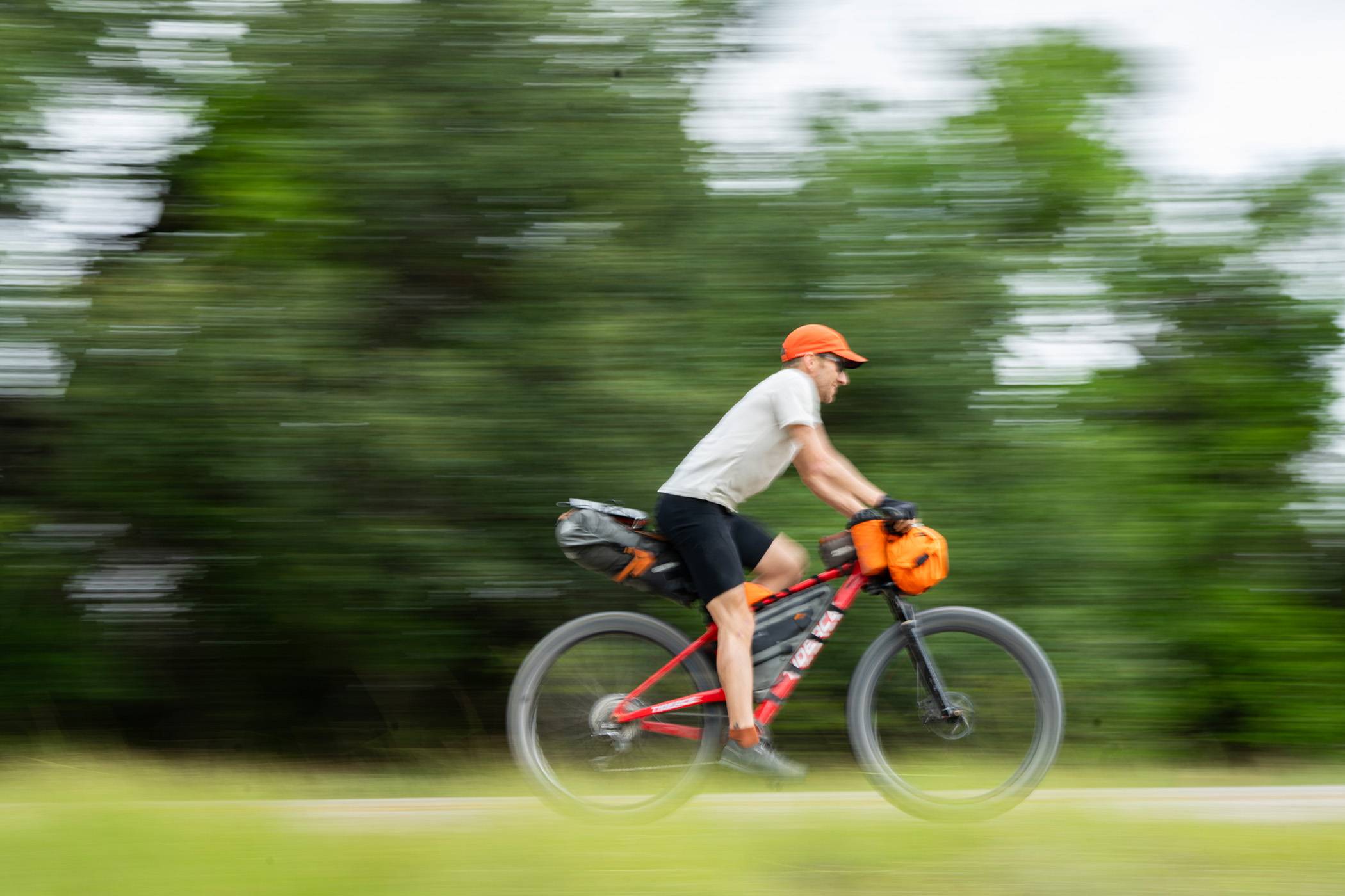 Landauer speeds past on his bicycle down a desolate stretch of Texas backroads.