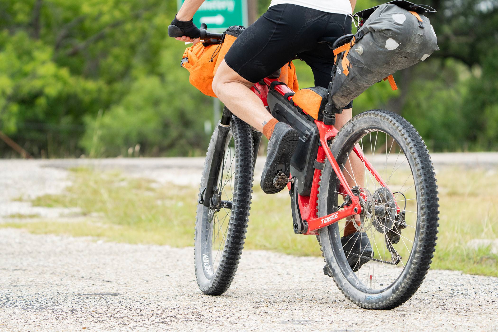 Close-up of Landauer's feet and bike tires as he kicks off into a ride.